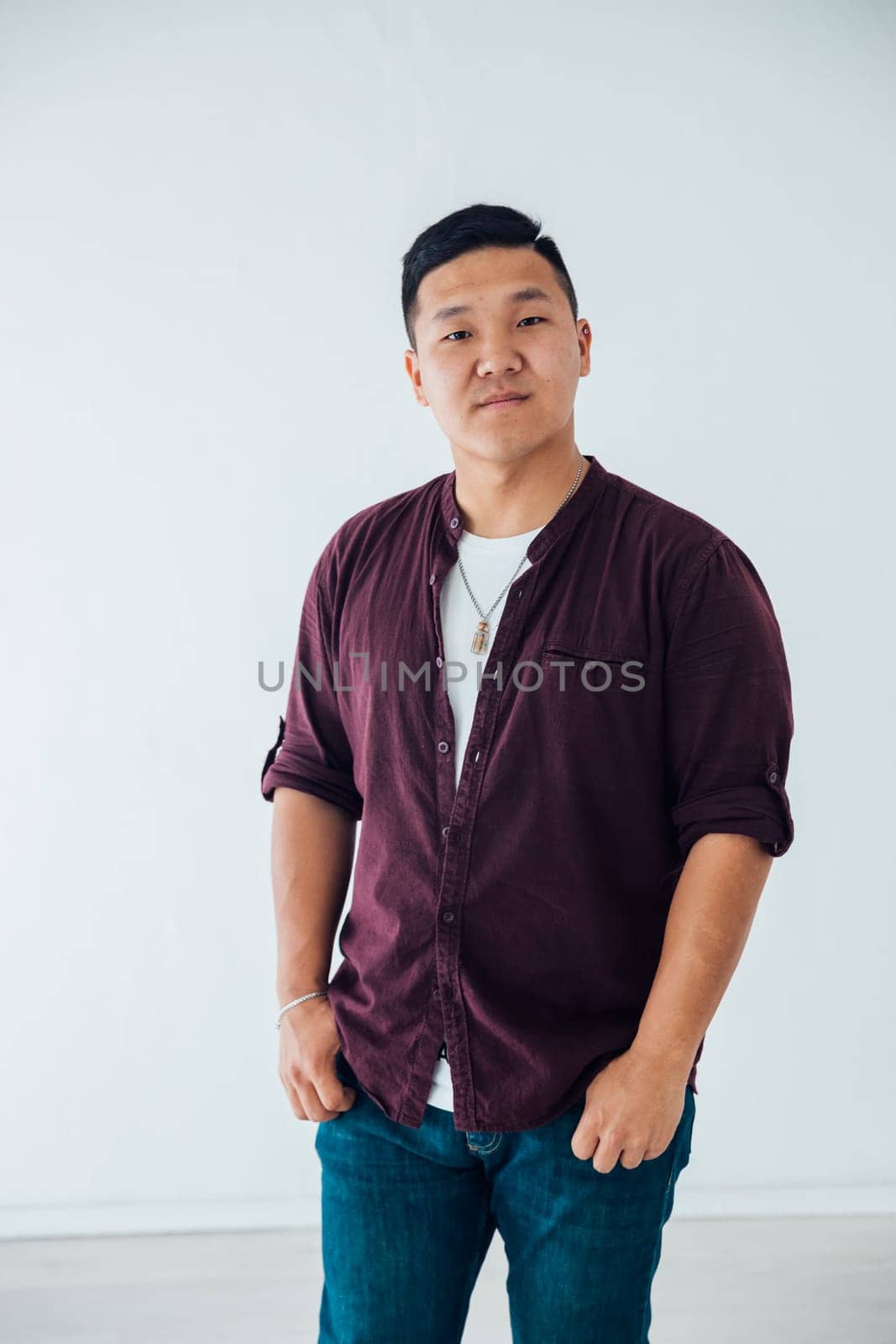 Portrait of Asian man in shirt and jeans on white background