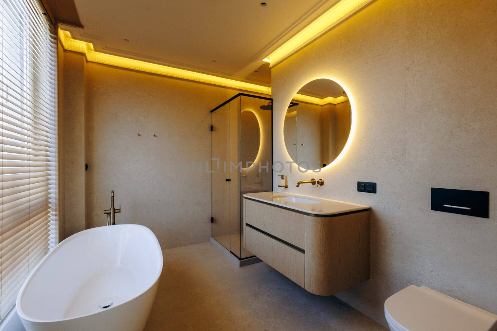 This is a welldesigned bathroom that includes a bathtub, a sink, a toilet, and a mirror, all essential for any bathroom space