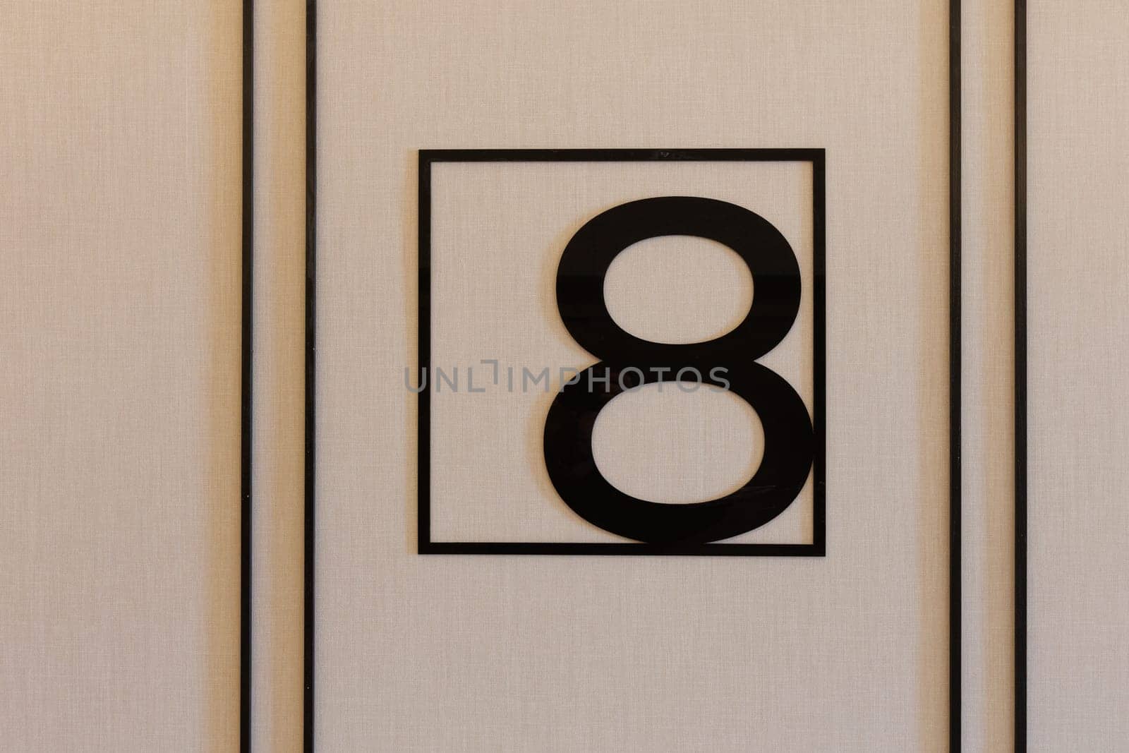 A striking black and white sign displaying the number eight prominently on it, serving as an essential part of house numbering