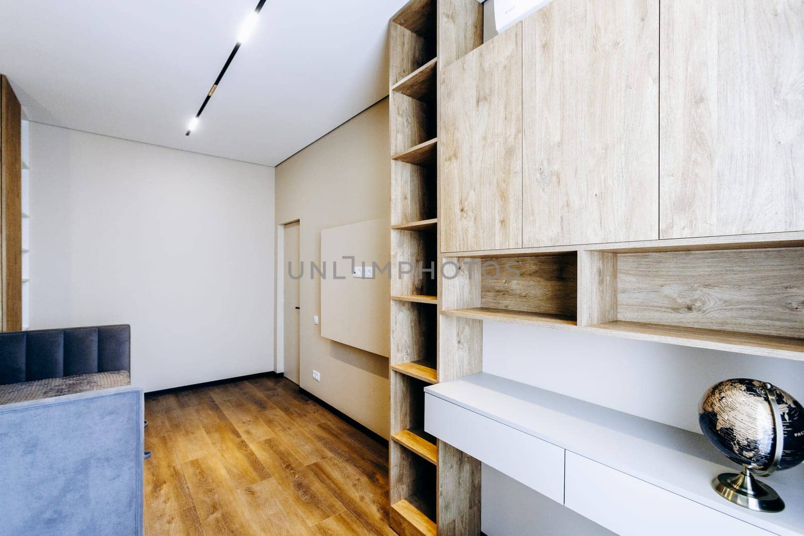In the center of the room, on the shelf, there is a notable globe that draws attention from anyone who enters the space
