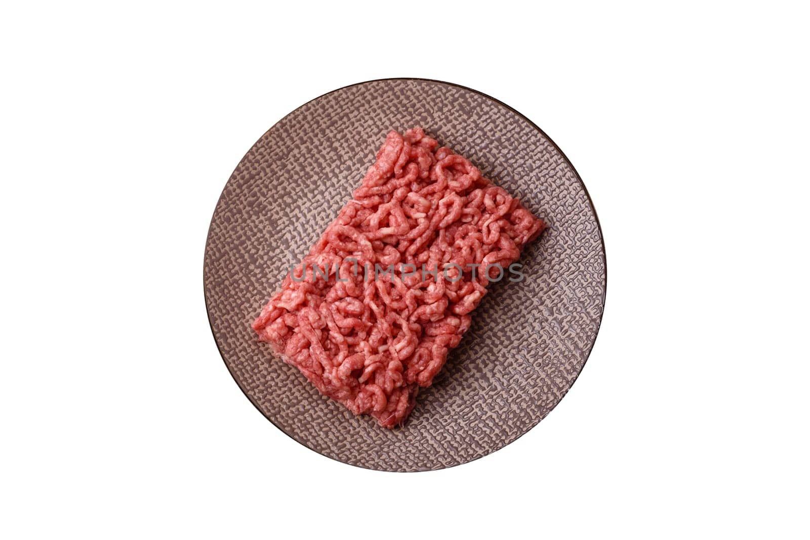 Stuffing or ground raw beef or pork with salt and spices on a black background