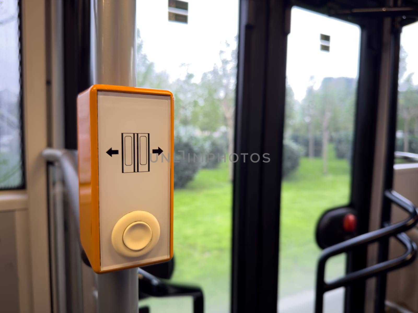 Security and control element inside public transit system: a door operation button enabling passengers to manage entry and exit safely and efficiently. Push button for door opening