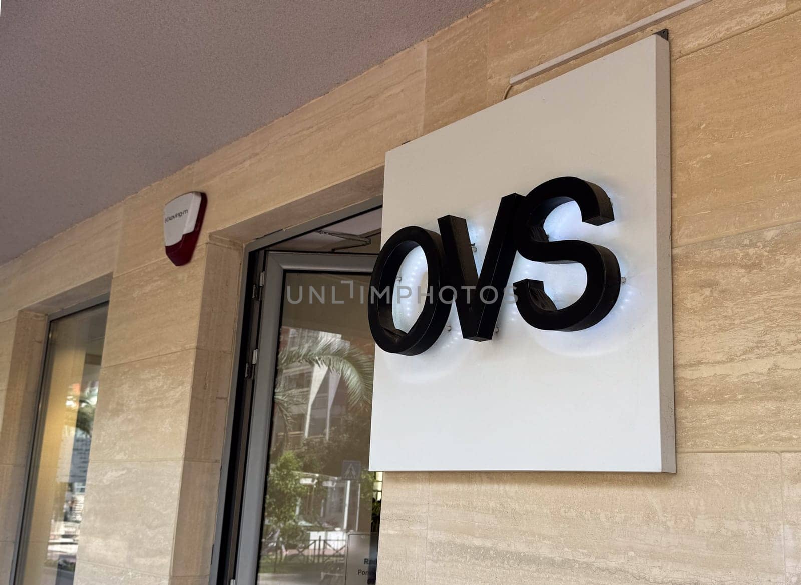 Budva, Montenegro - April 18, 2025: Close-up of the sign of the popular OVS retail store on the wall of the building at the entrance to the store