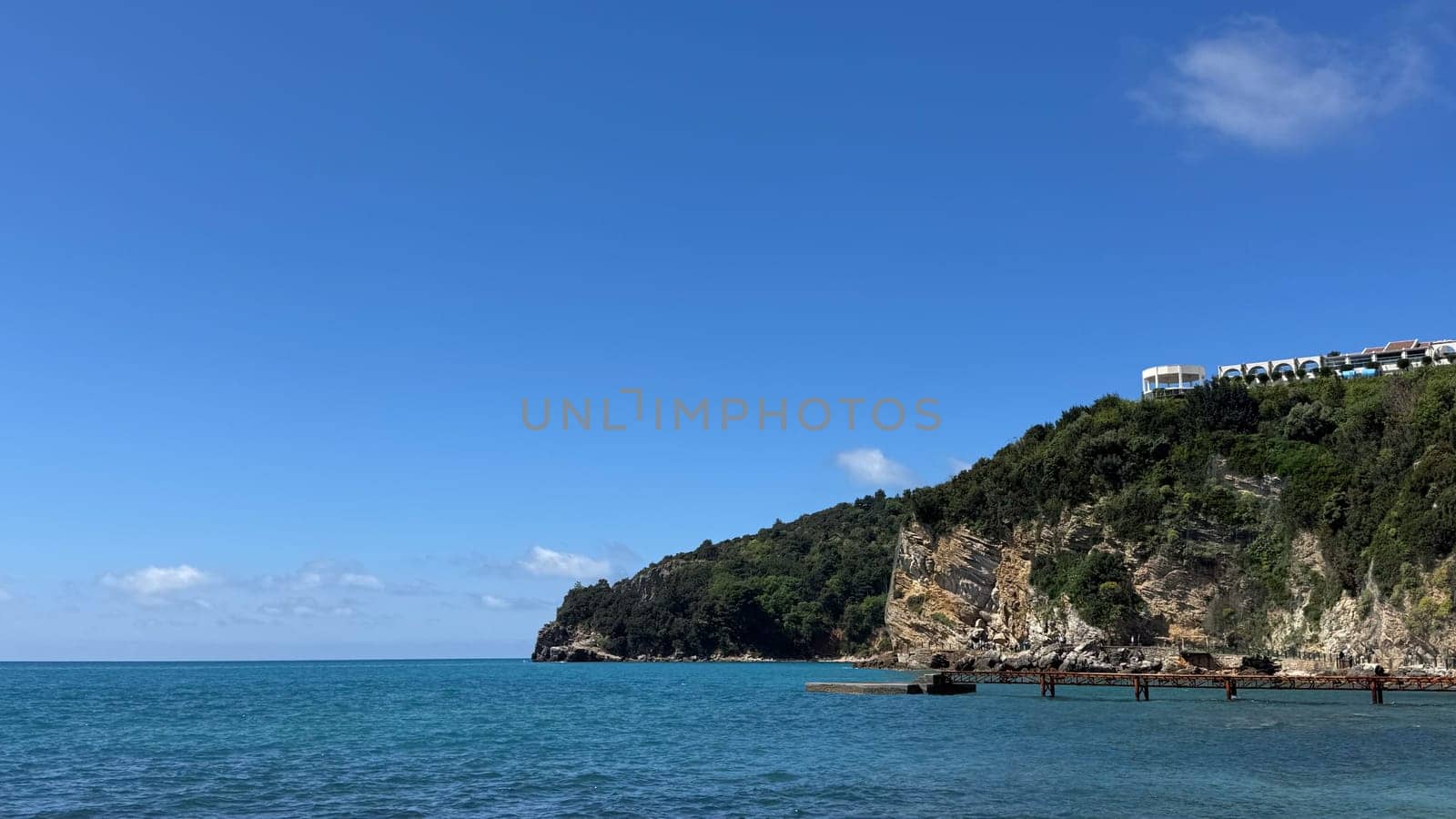 Budva, Montenegro - April 18, 2025: Coastal landscape showcasing cliffs and clear waters, embodying tranquility and natural beauty in a serene environment