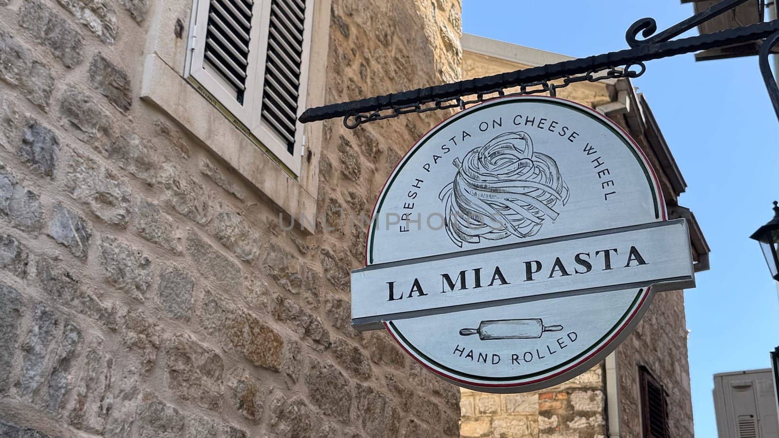 Budva, Montenegro - April 18, 2025: La Mia Pasta restaurant sign. Fresh pasta cooked in a cheese wheel, known as pasta alla ruota, is the most popular in the city.