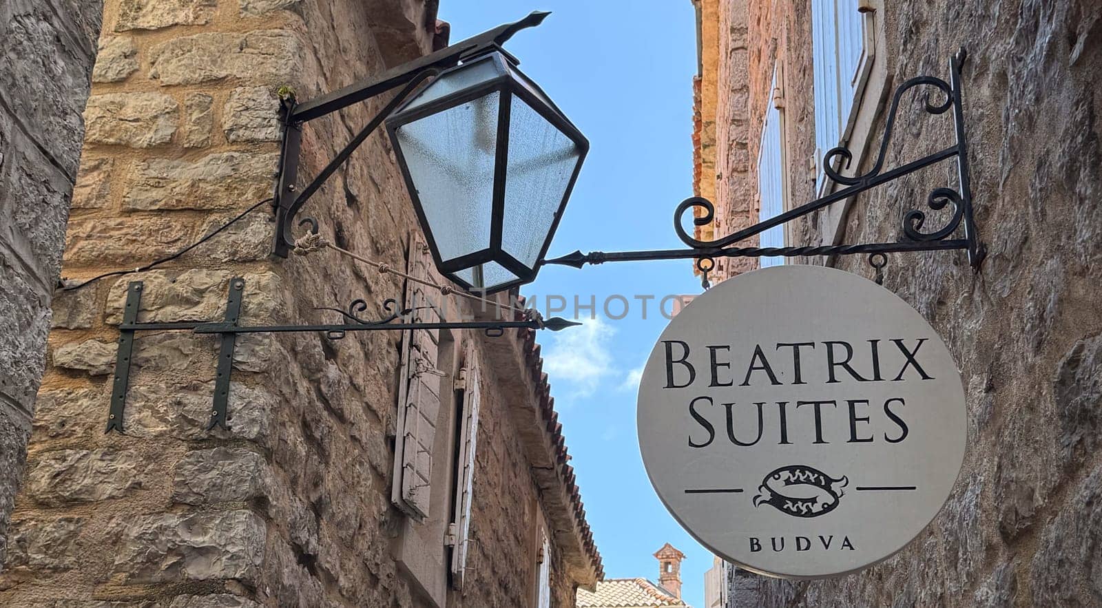 Budva, Montenegro - April 18, 2025: The inscription of the BEATRIX SUITES hotel on the wall of a building on one of the streets of the old town of Budva.
