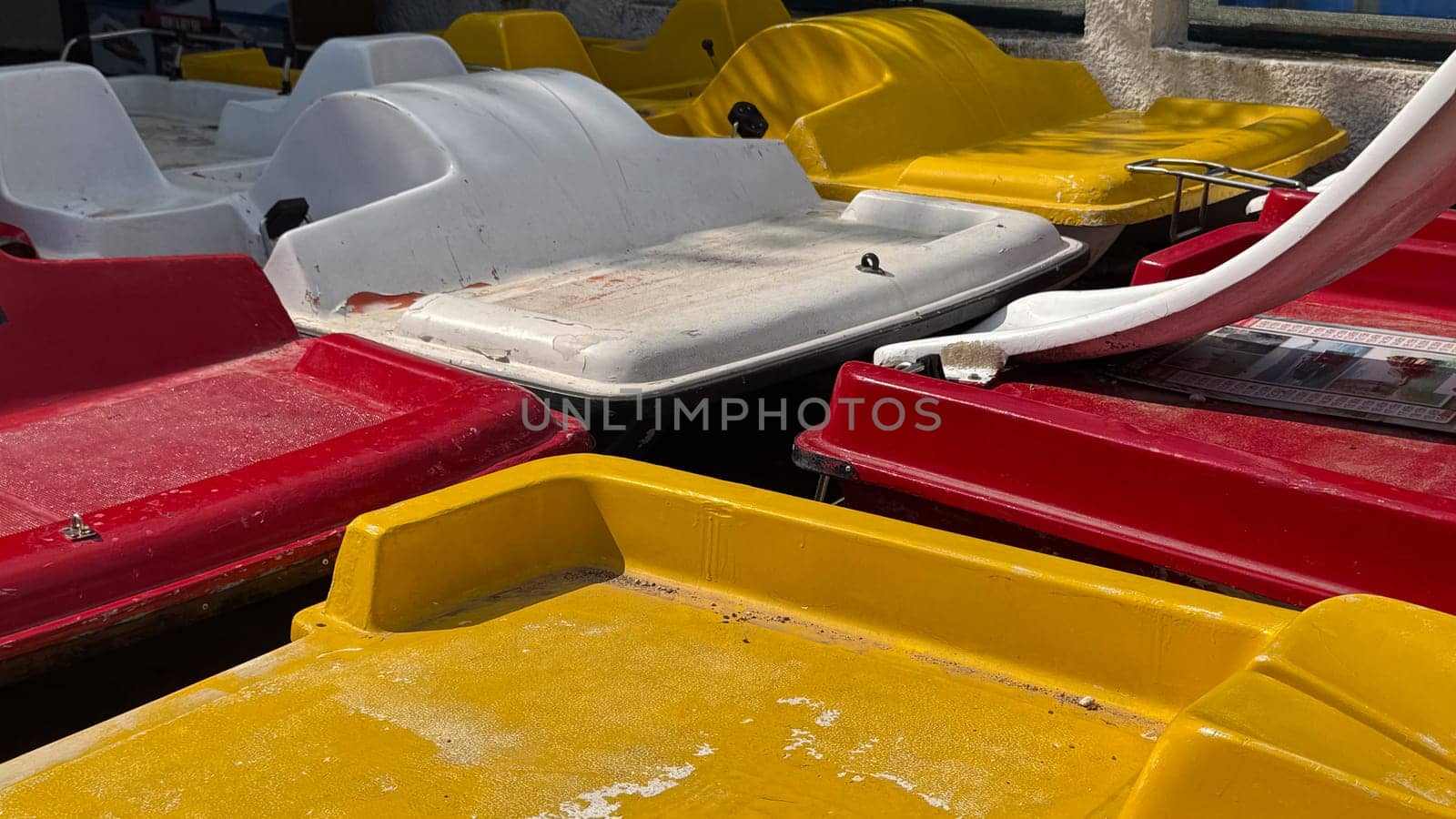 Budva, Montenegro - April 18, 2025: Colorful pedal boats are closely located on the waterfront, showcasing a vibrant outdoor theme