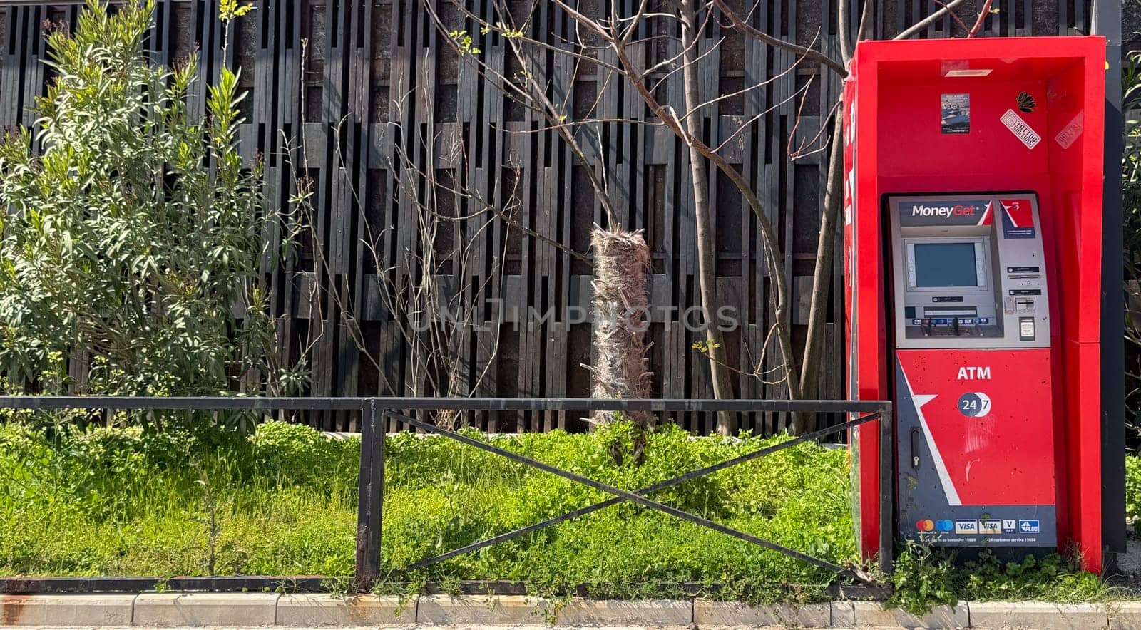 Budva, Montenegro - April 18, 2025: Red MoneyGet ATM located on the embankment of Slavyanski Beach
