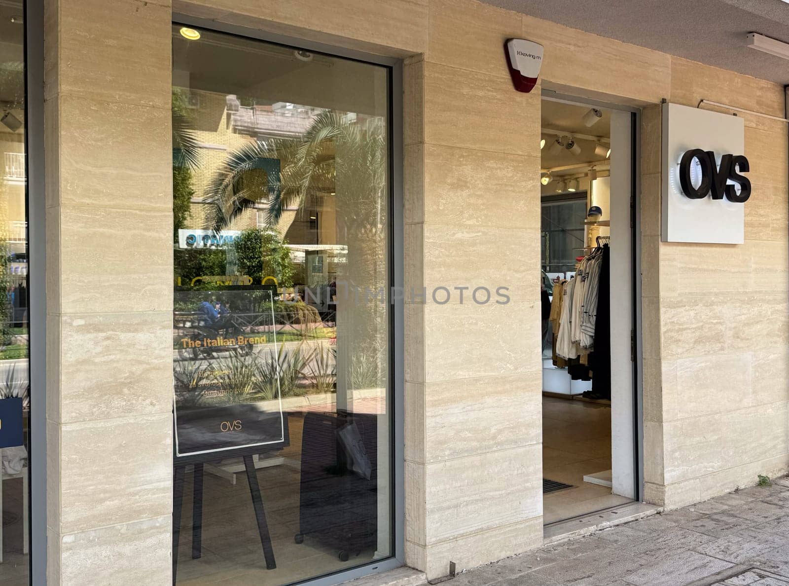 Budva, Montenegro - April 18, 2025: OVS sign at the door of the store The exterior of the OVS retail store emphasizes modern design