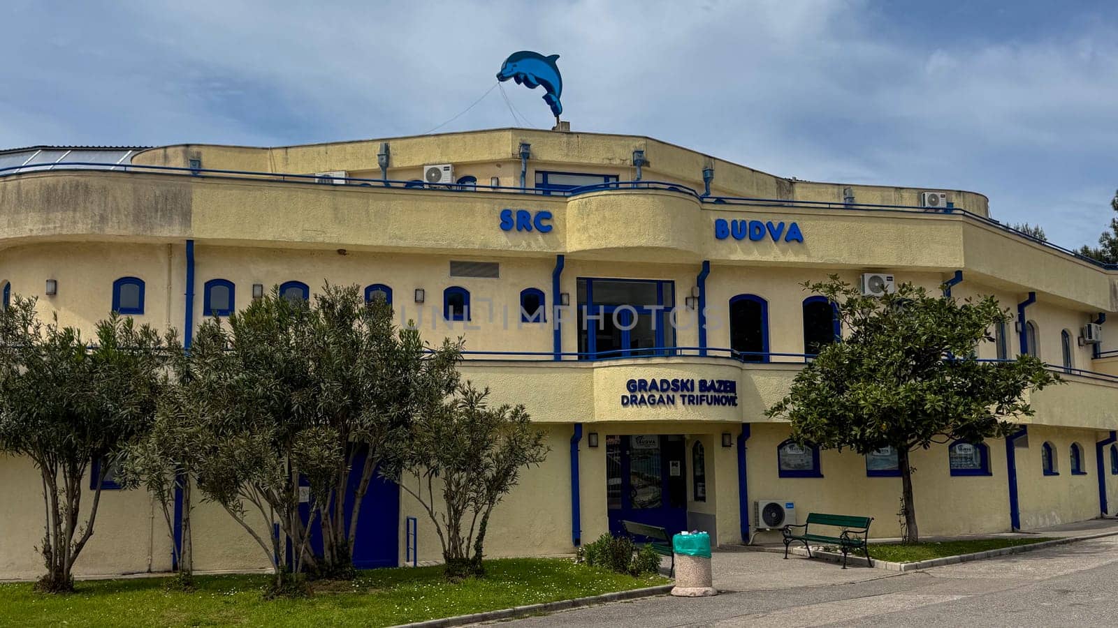 Budva, Montenegro - April 18, 2025: SRC Budva is an aquatic center with a sculpture of a dolphin that promotes the development of water sports and the involvement of society in a dynamic environment.