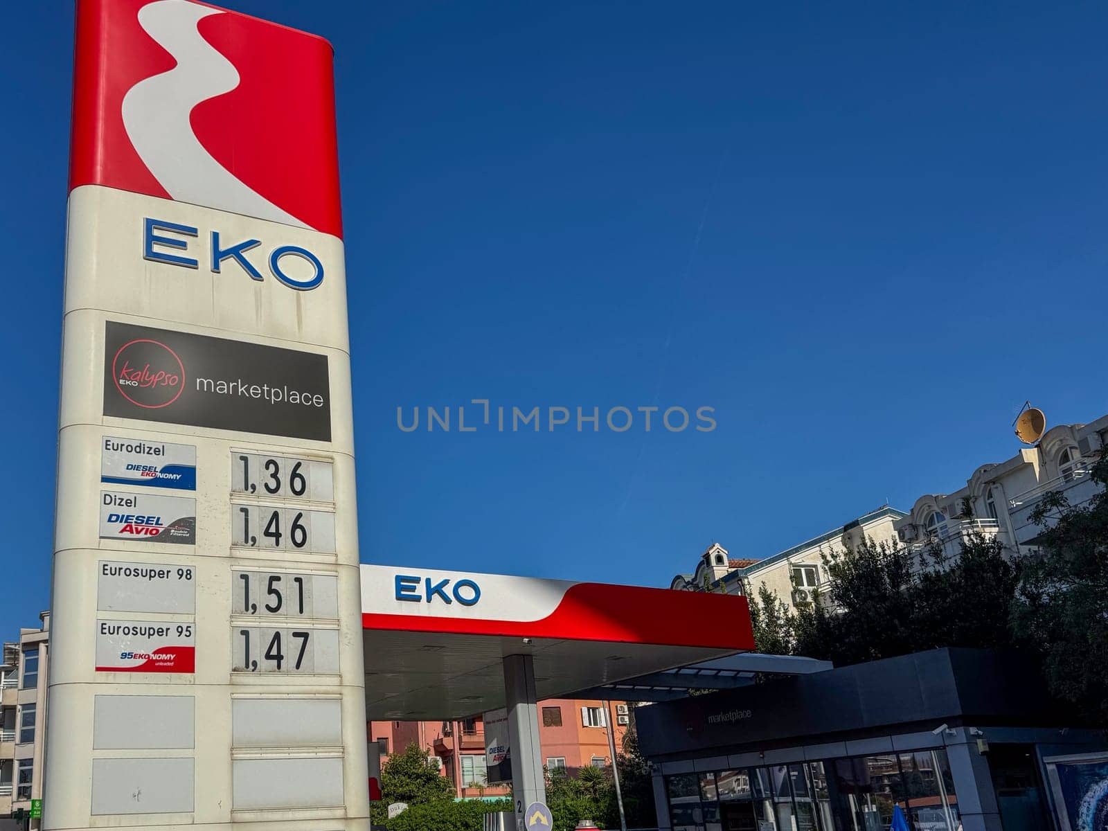 Budva, Montenegro - April 18, 2025: The EKO gas station price display in an urban environment shows the different fuel price options and the marketplace.convenience and accessibility for customers