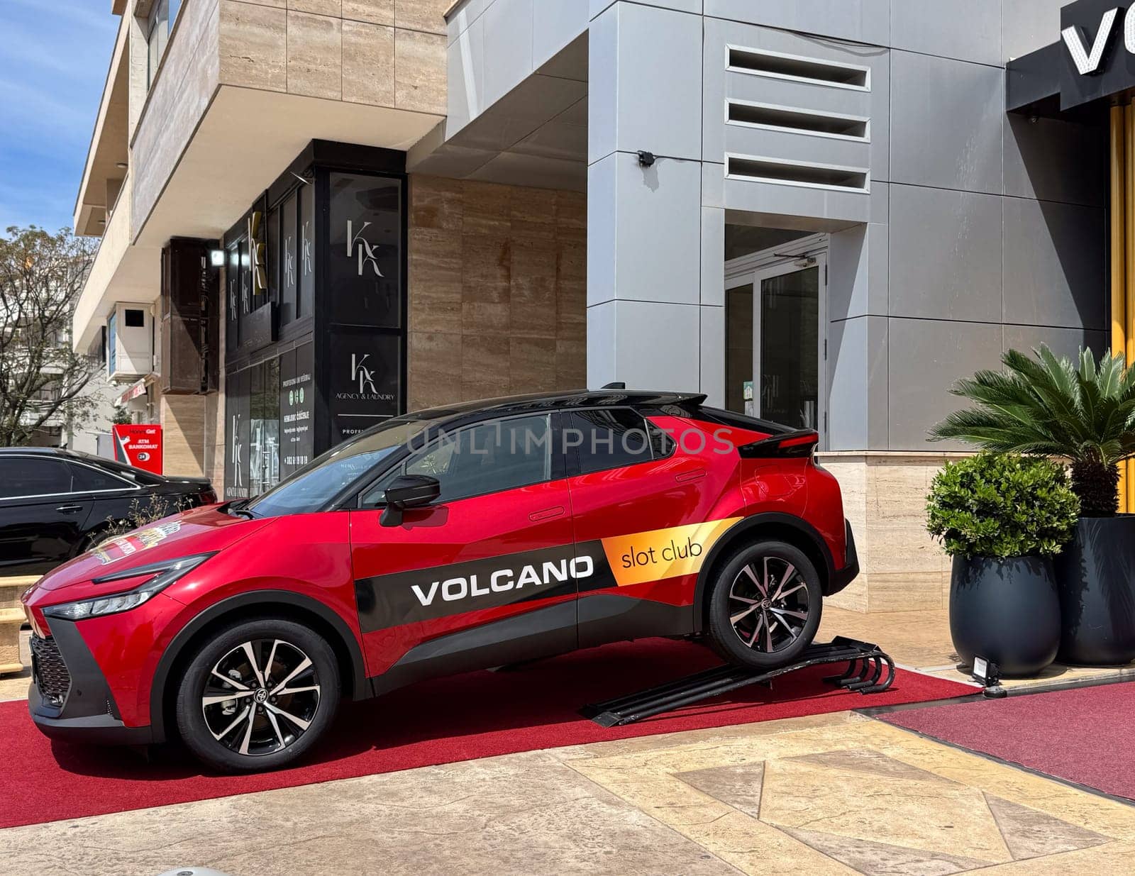 Budva, Montenegro - April 18, 2025: Red Toyota car in front of the Vulkan Slot club, as a casino prize