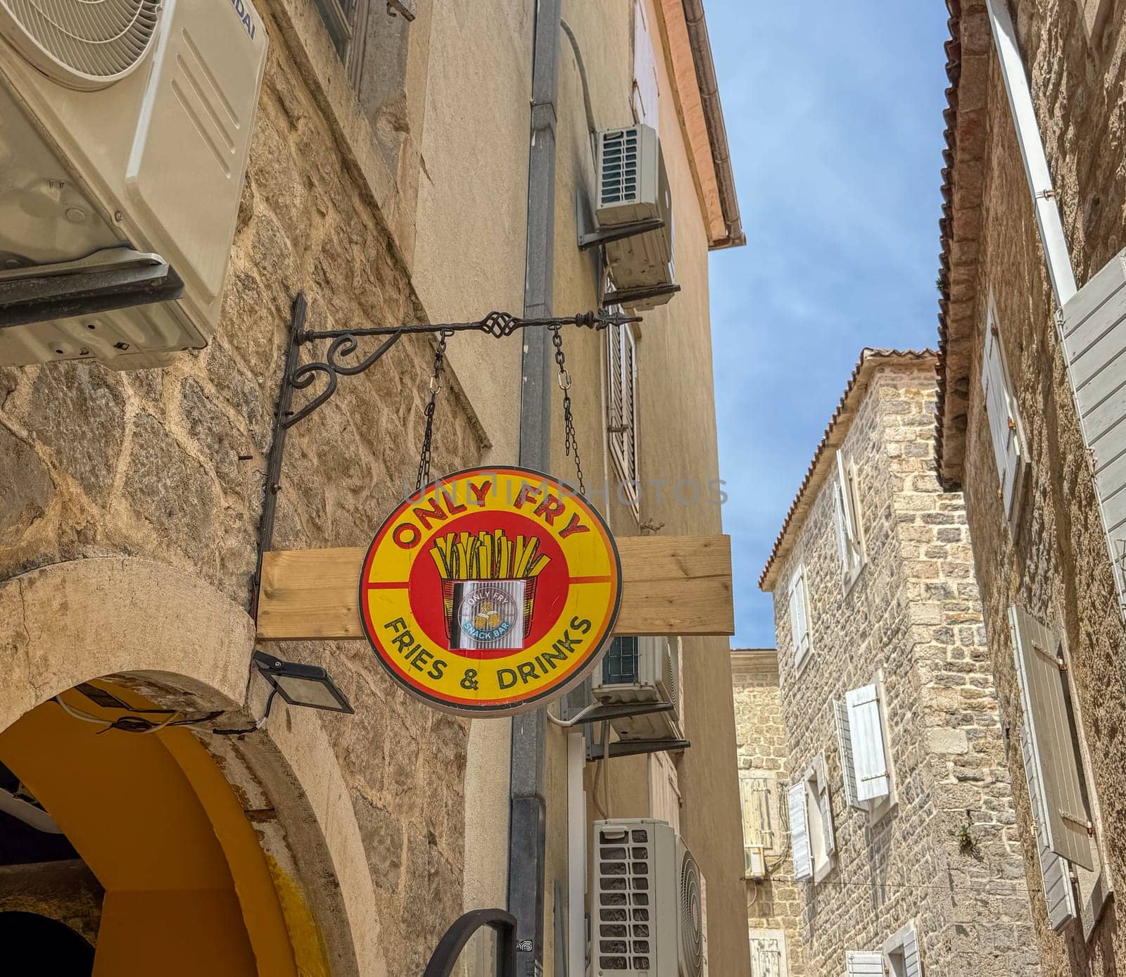 Budva, Montenegro - April 18, 2025: Only Fry restaurant sign on the wall of a house in the old town. highlights the appeal of delicious fries in a street atmosphere