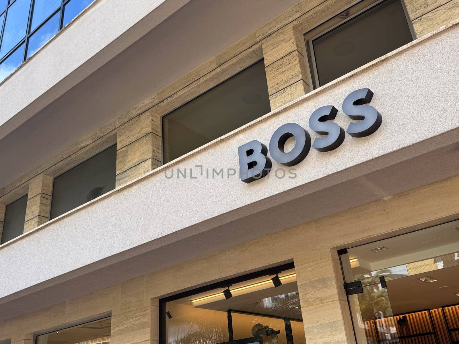 Budva, Montenegro - April 18, 2025: BOSS brand showcase located in an urban environment. architecture and retail experience.