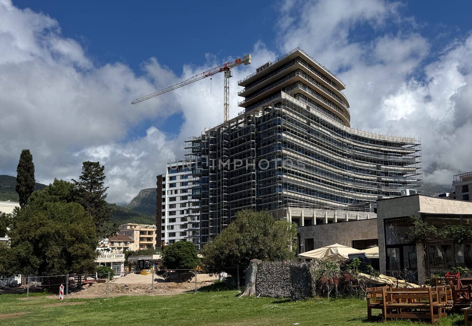 Budva, Montenegro - April 18, 2025: Construction of the large Hotel Falcons next to the waterfront, construction crane and ongoing works.