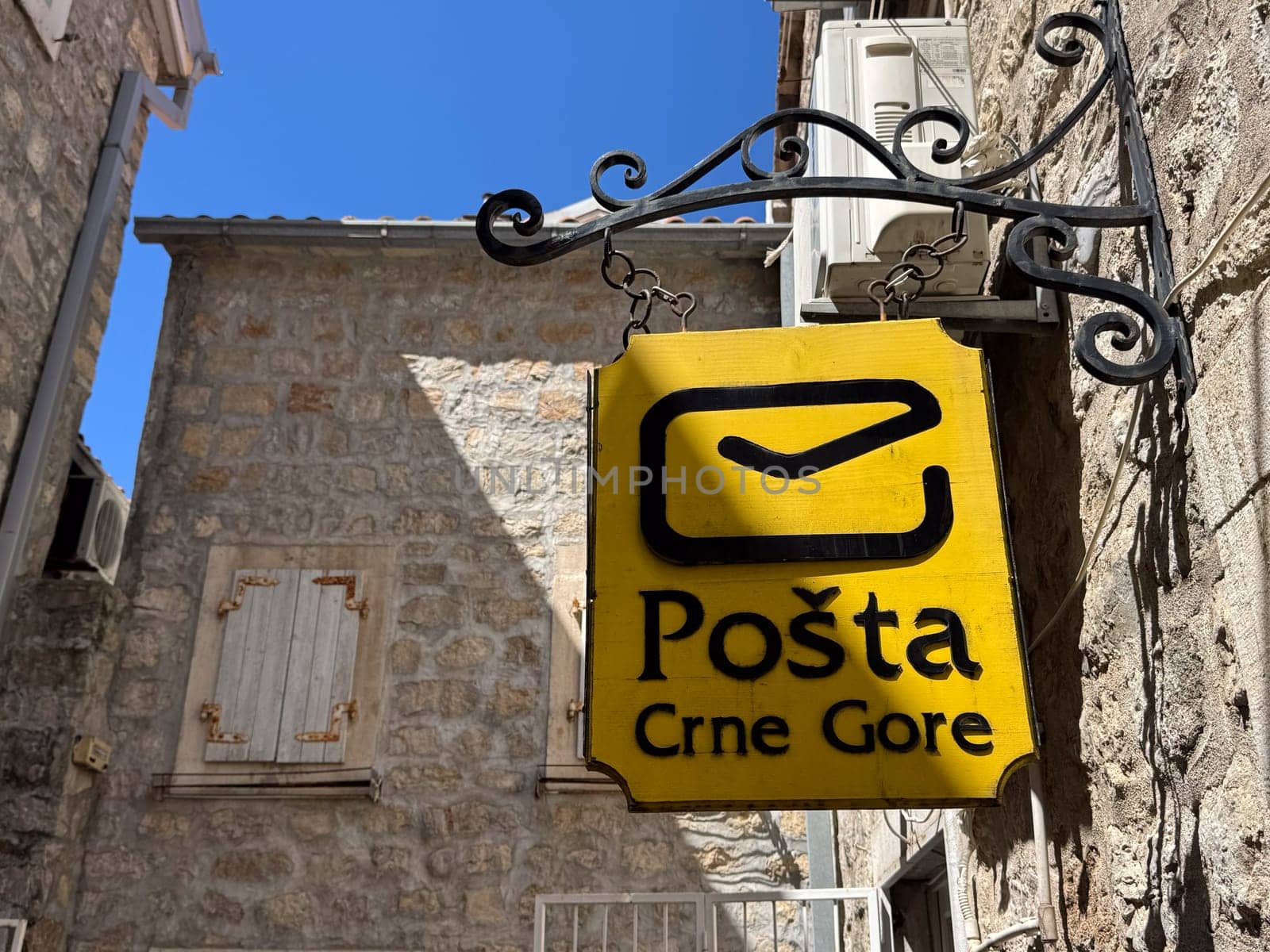 Budva, Montenegro - April 18, 2025: The sign of the postal service in Montenegro on the wall of a building in the Old Town reflects the local culture and identity