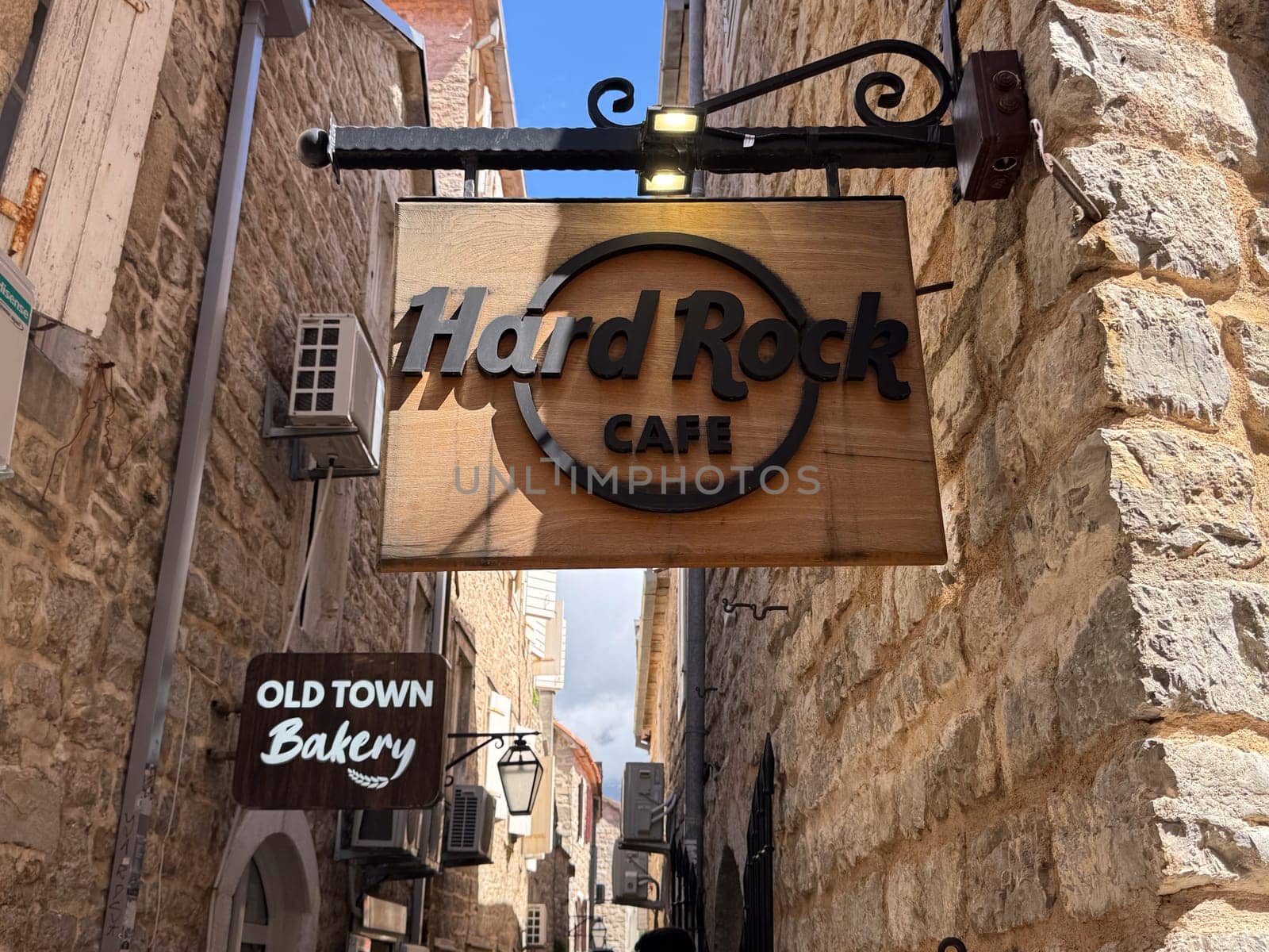 Budva, Montenegro - April 18, 2025: Hard Rock Cafe sign on the wall in the Old Town. Hard Rock Cafe is an international restaurant chain founded in 1971, known for its unique atmosphere