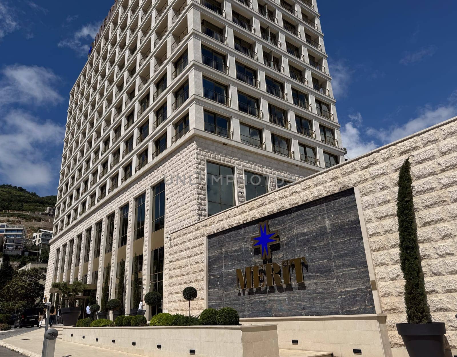 Budva, Montenegro - April 18, 2025: The modern architectural design of the Merit Hotel showcases luxurious hospitality in a picturesque location, emphasizing elegance and comfort