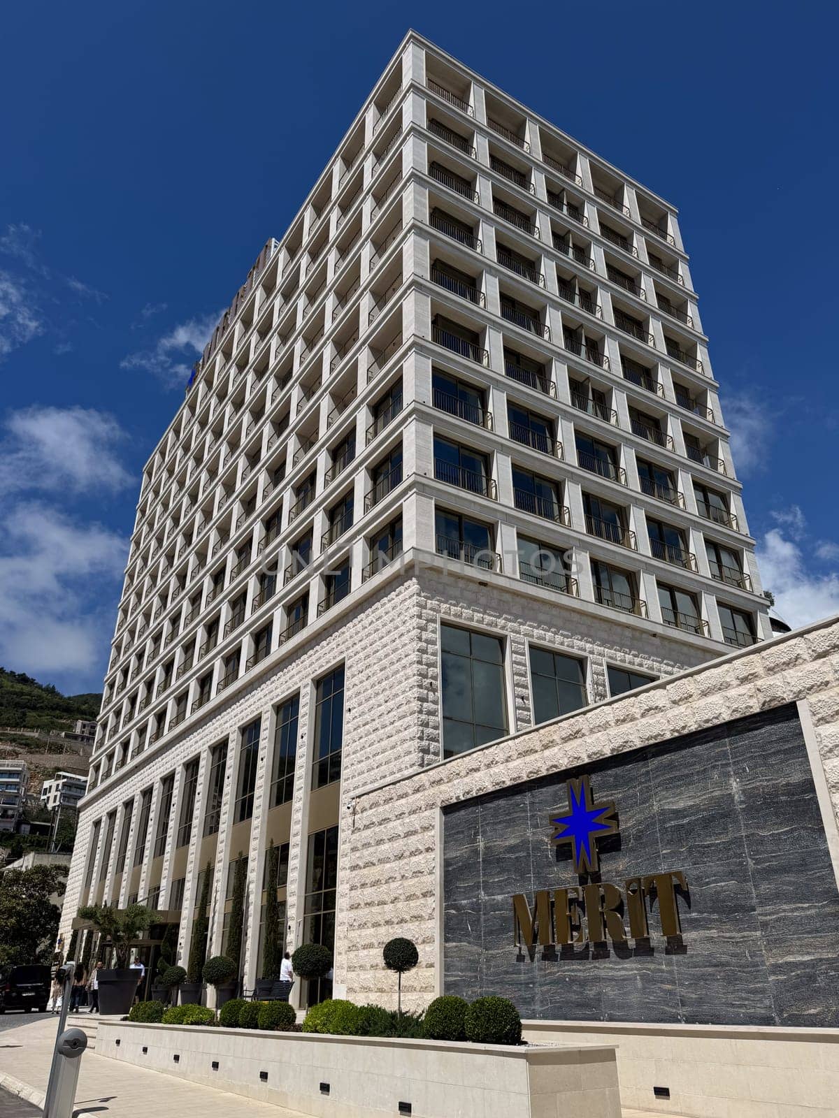 Budva, Montenegro - April 18, 2025: The modern architectural design of the Merit Hotel showcases luxurious hospitality in a beautiful location, highlighting elegance and comfort for guests seeking relaxation