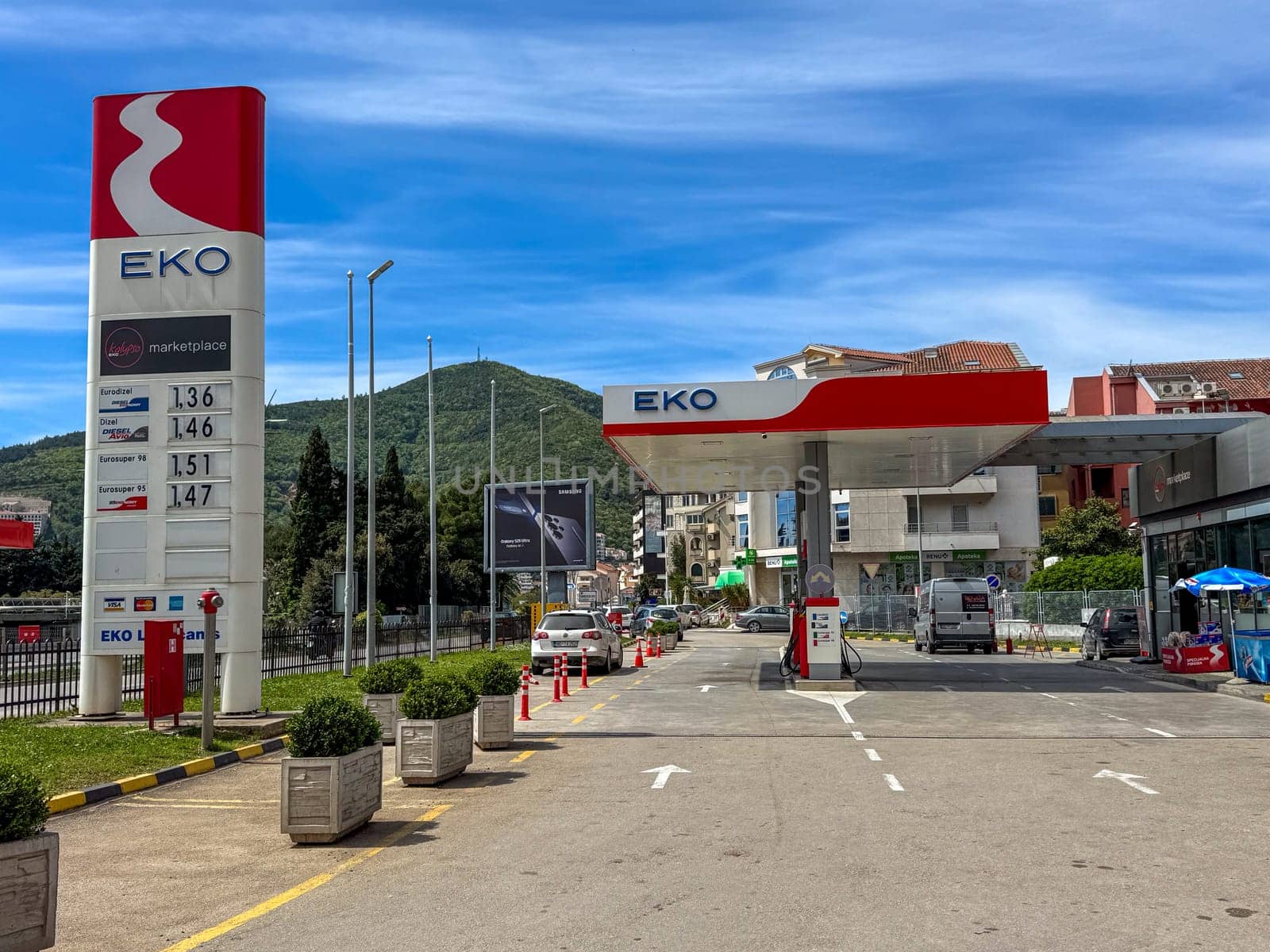Budva, Montenegro - April 18, 2025: EKO gas station, located in an urban environment, with a price display and lush greenery nearby, demonstrates modern infrastructure and convenience