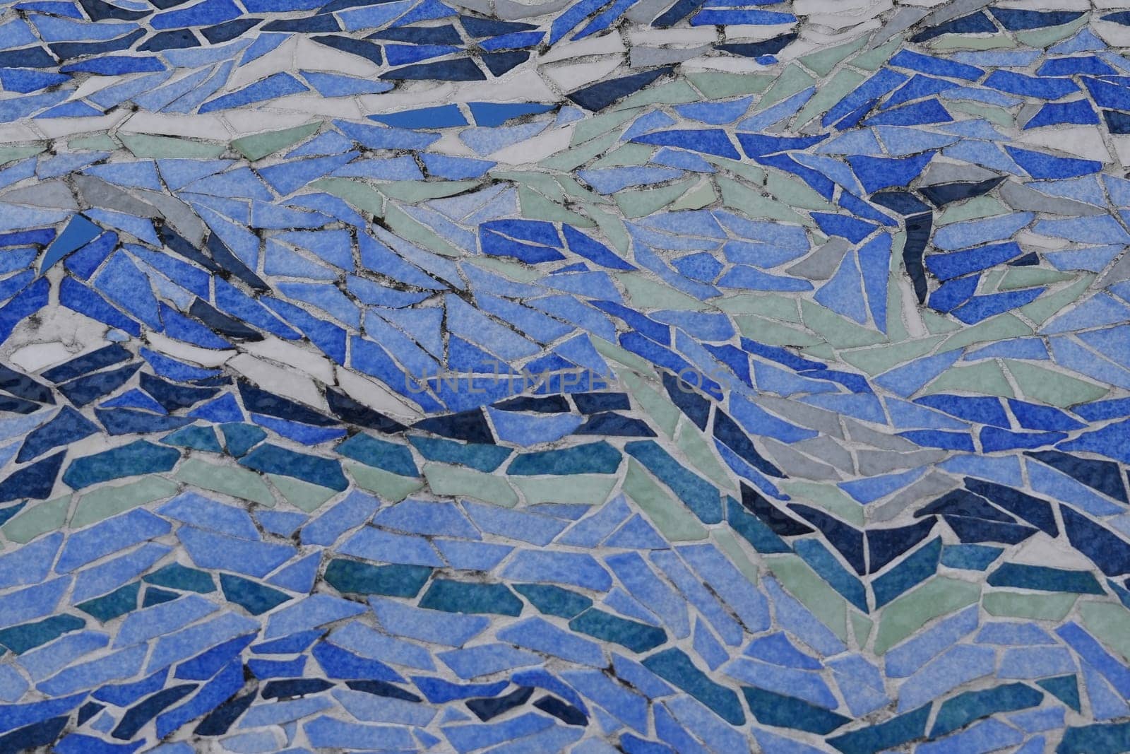 Blue art ceramic mosaic on the floor, mosaic background. colorful mosaic. texture mosaic.
