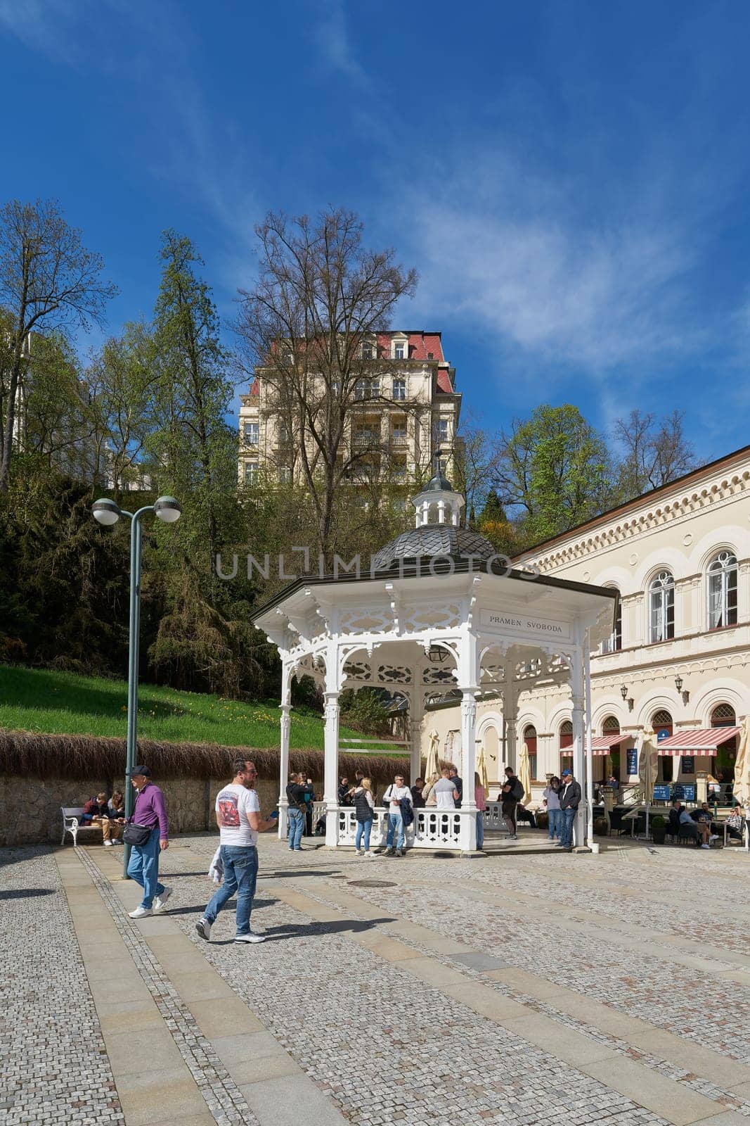 Karlovy Vary, Czech Republic – April 20, 2025: Tourists from all over the world at Pramen Svoboda, one of the many healing springs in the spa town of Karlovy Vary in the Czech Republic