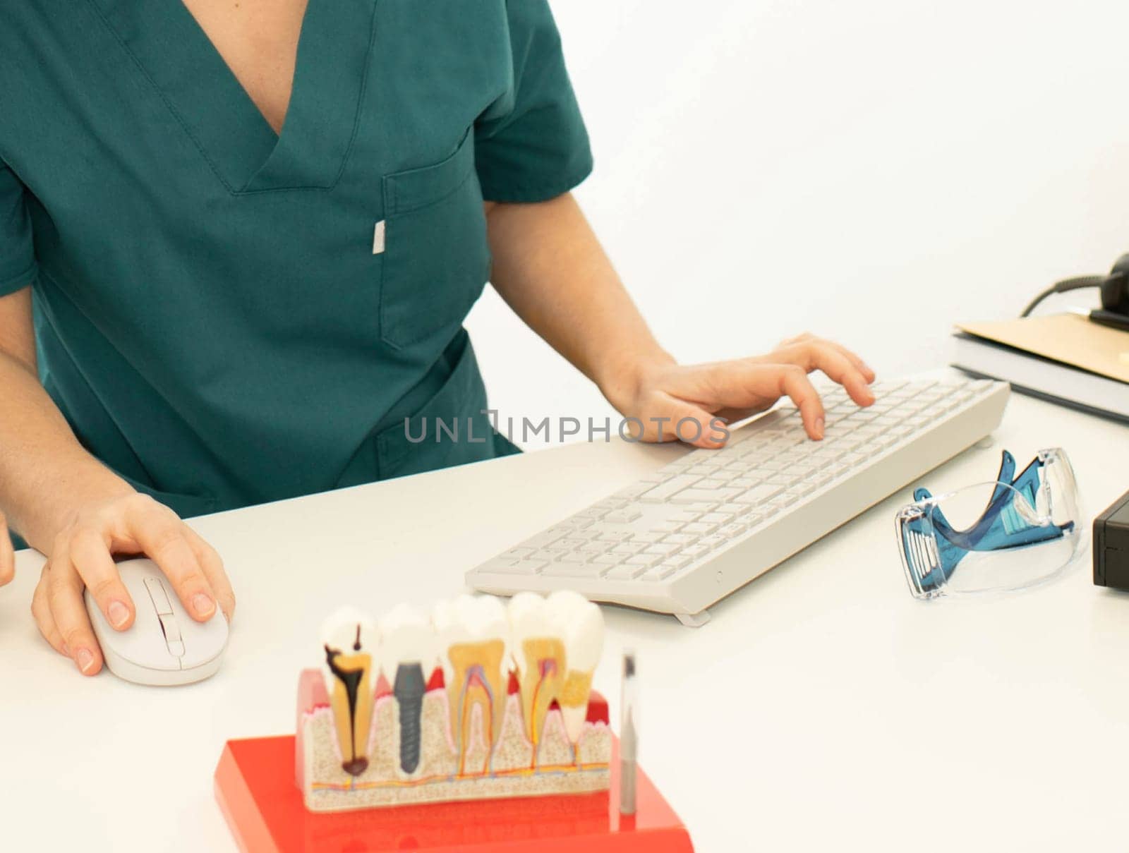 Dentists implantologists, On the table there is a model with teeth implants