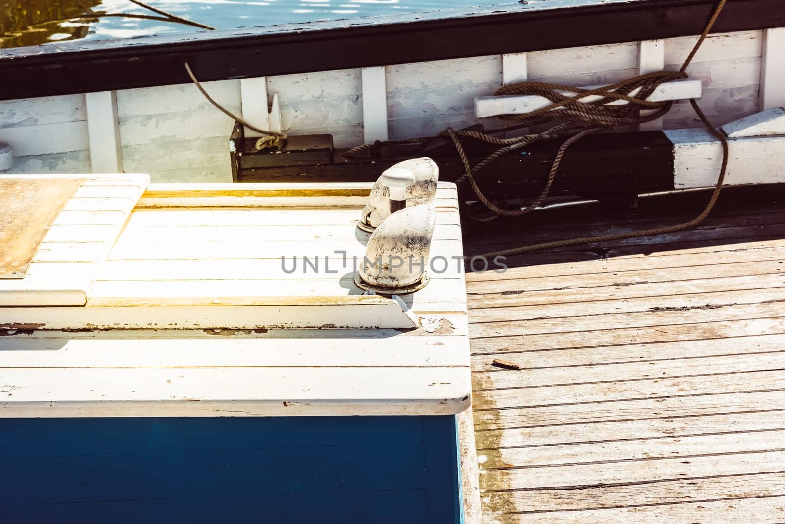 Boat deck with nautical ropes and wooden planks in sunlight background