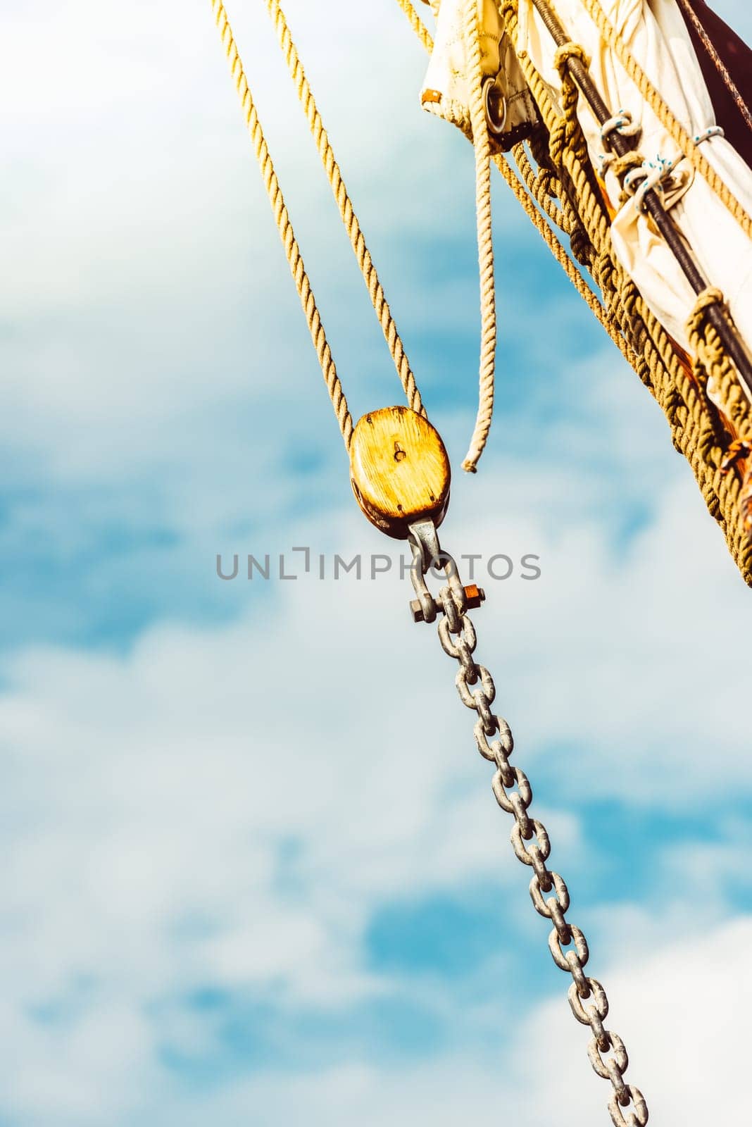 Sailboat rigging details against bright sky background, ocean theme