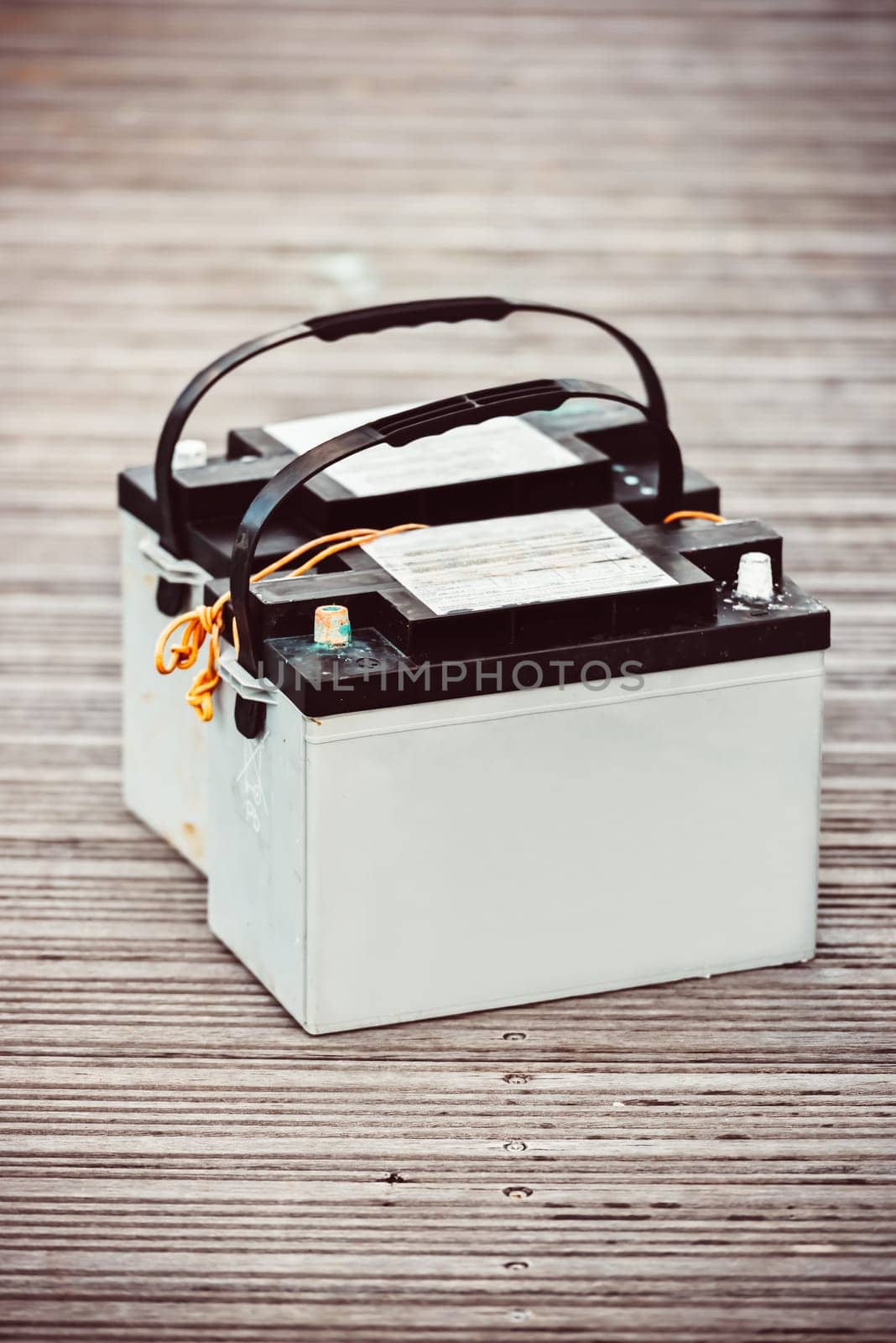 Car batteries sitting on wooden floorboards, industrial concept