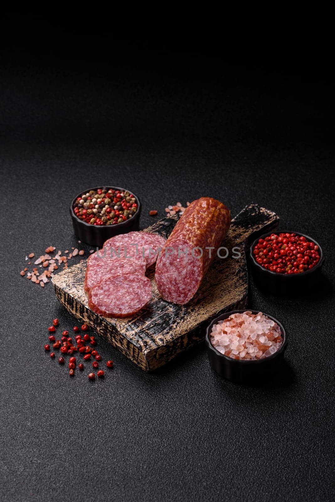 Sliced salami sausage, smoked meat, delicious deli snacks on a plate