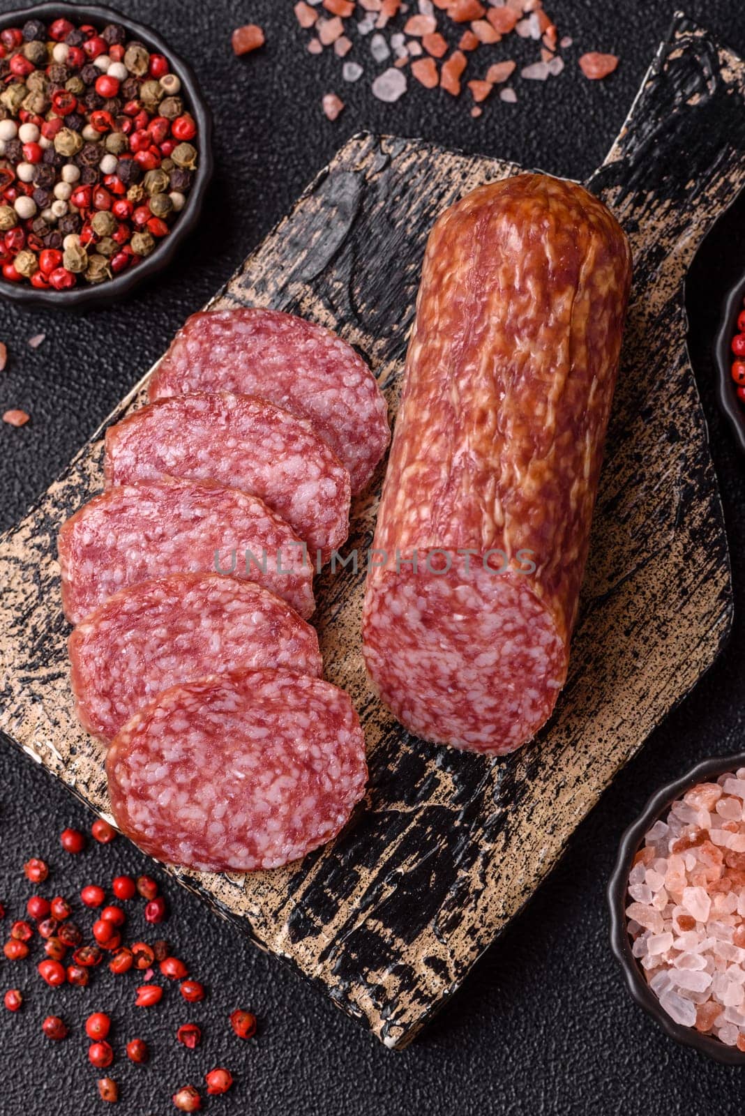 Sliced salami sausage, smoked meat, delicious deli snacks on a plate