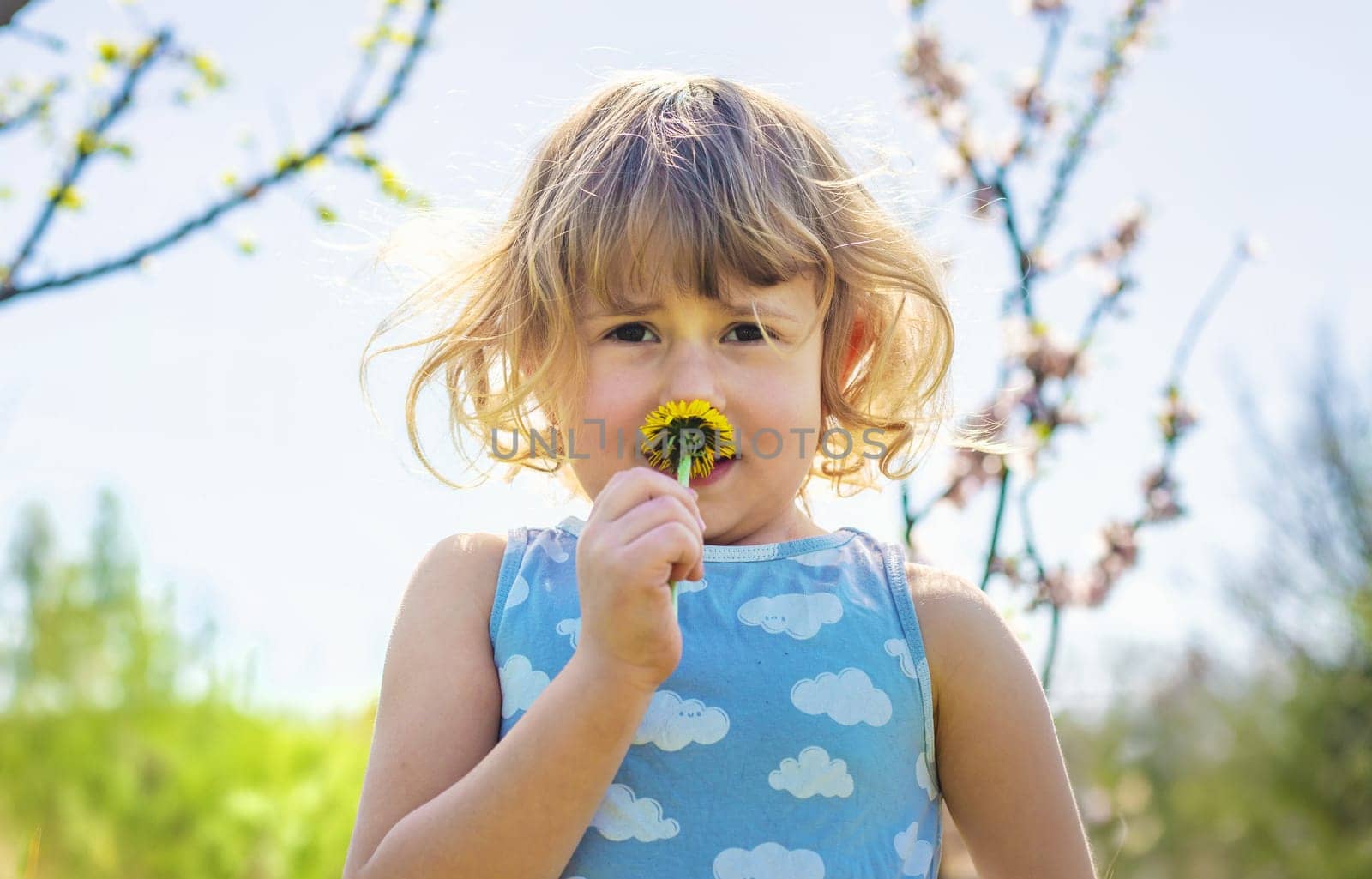 Child in a garden of flowering trees. Selective focus. kid.