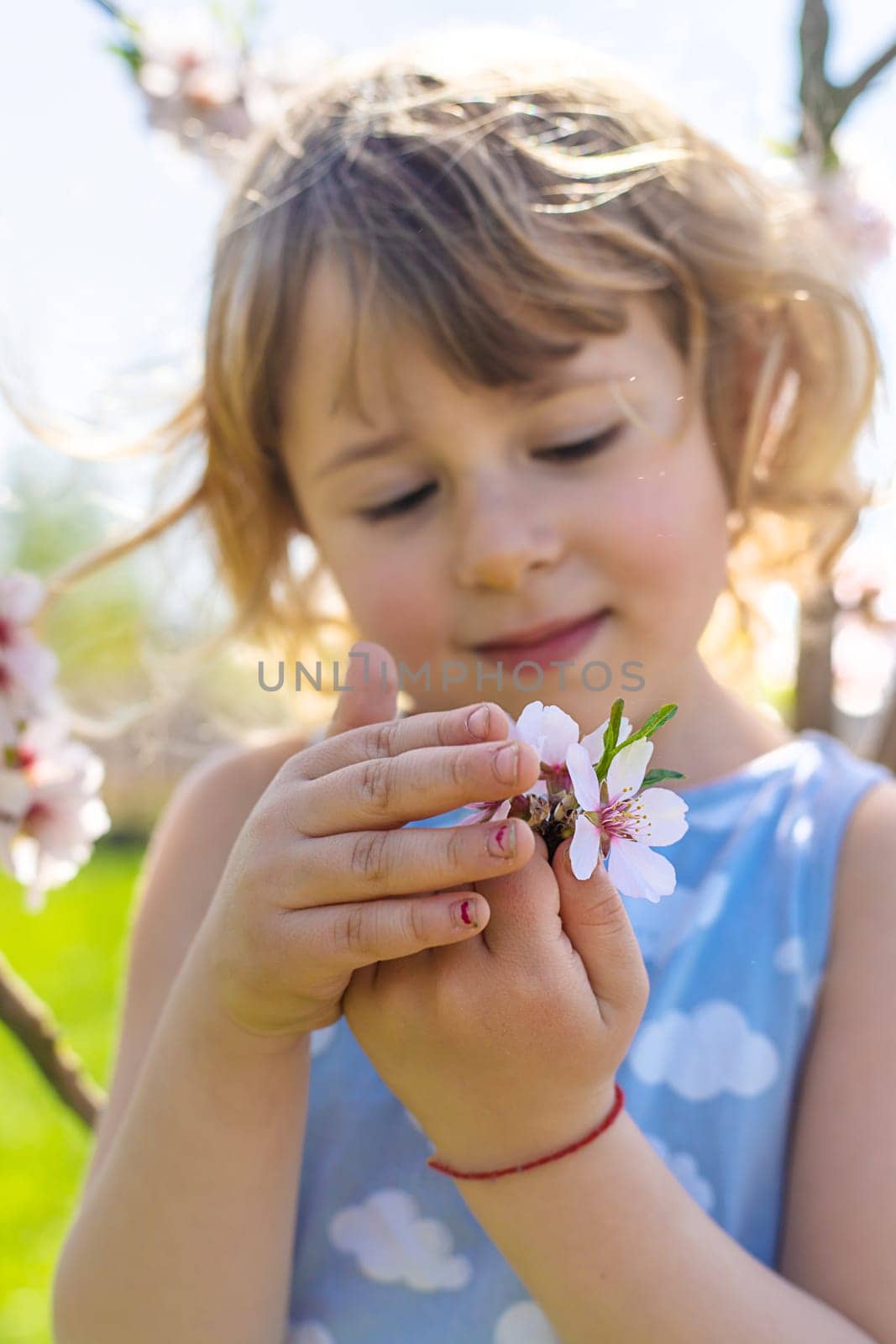 Child in a garden of flowering trees. Selective focus. kid.