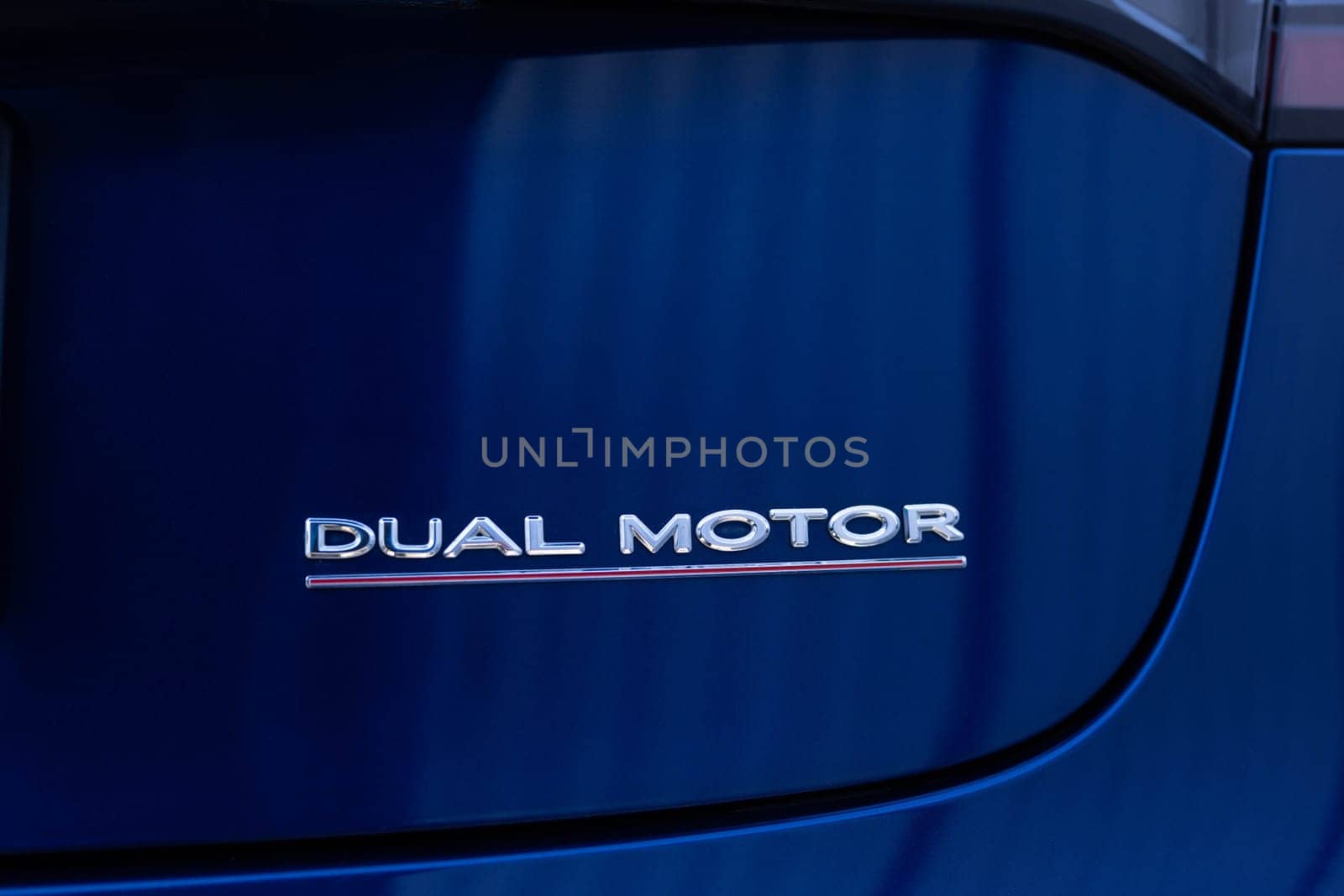 Lviv, Ukraine - April 17, 2025: Tesla Model 3 dual motor performance logo rear view. Electric car parked on parking lot.