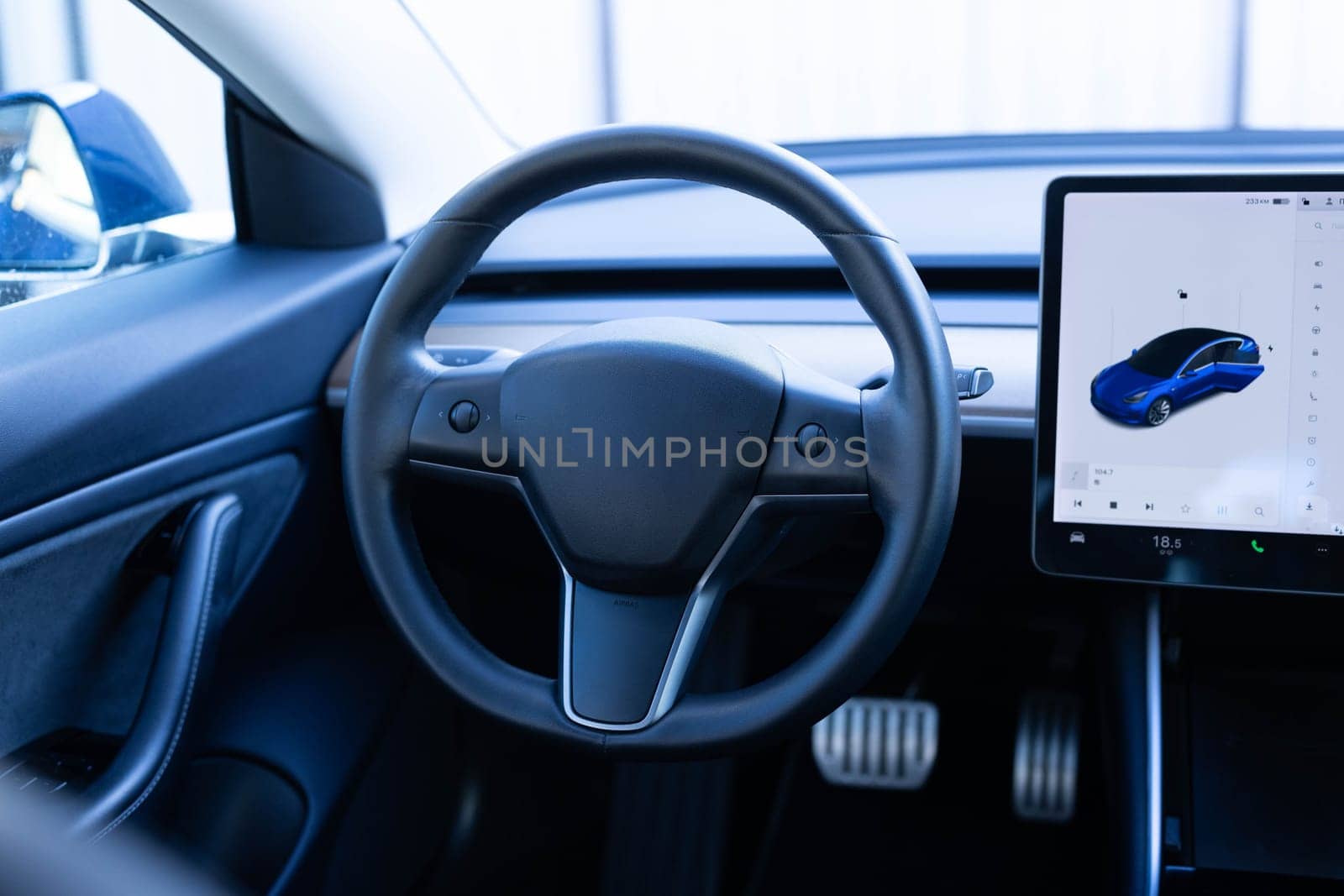 Close up of steering wheel of a new electric vehicle, interior cockpit, electric buttons, digital speedometer. Electric car control devices. Cruise control buttons, speed limitation, car's signal.
