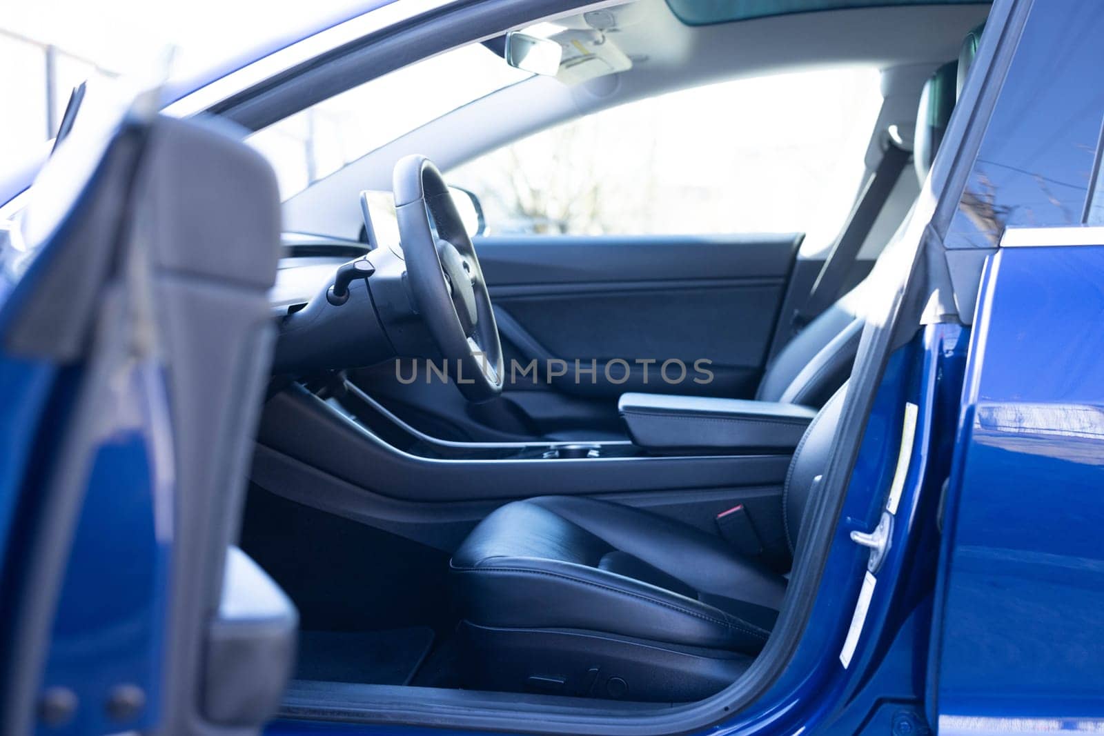 Car interior luxury inside. Steering wheel, dashboard, speedometer, display. Black leather interior. Modern luxury car Interior - steering wheel, shift lever and dashboard.