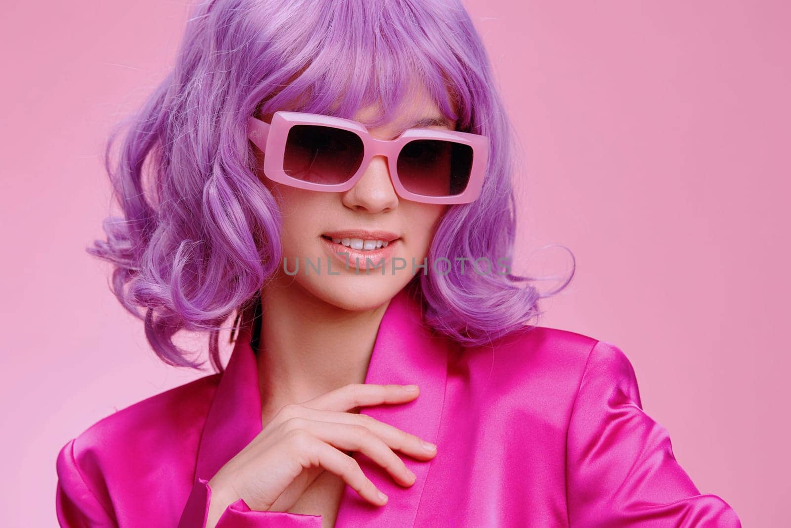 Pink background, a woman with purple hair wearing sunglasses and a pink suit, stylish and edgy fashion statement, vibrant and bold look, contemporary and chic aesthetic