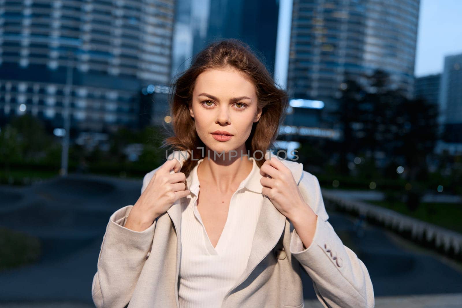 Empowering image of a business woman exuding confidence, dressed in chic attire against an urban landscape, perfect for conveying professionalism and ambition.
