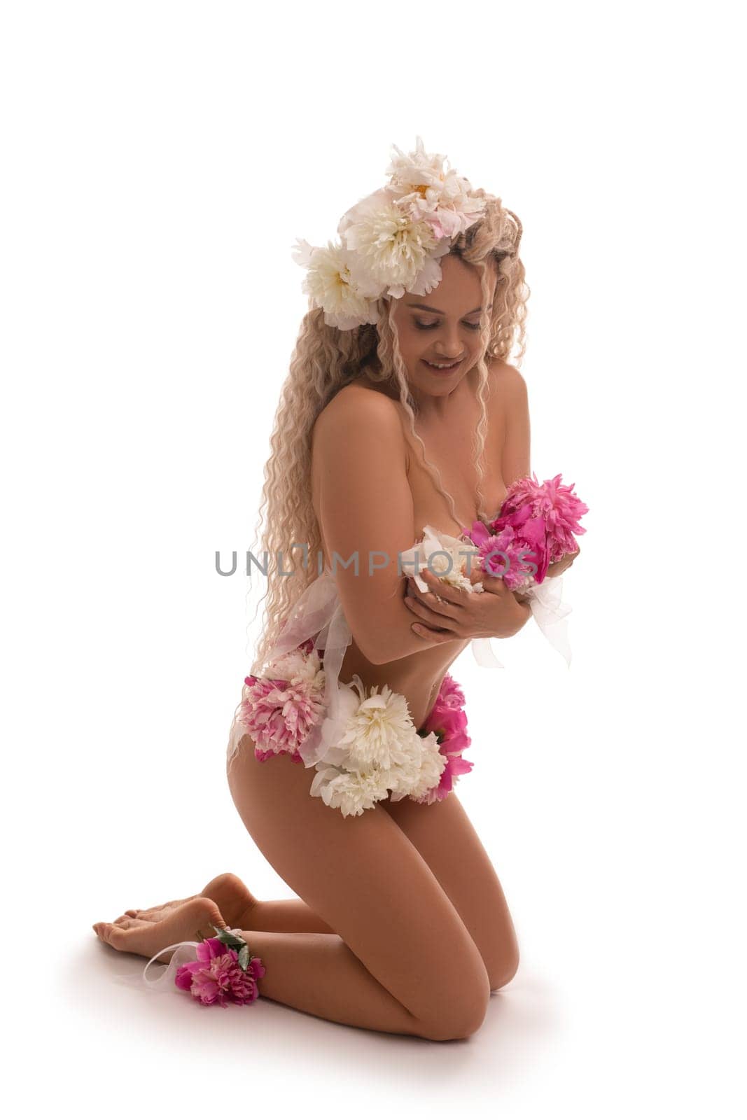 Full body side view of sensual young female in white lace lingerie and high heeled shoes looking at camera against white background