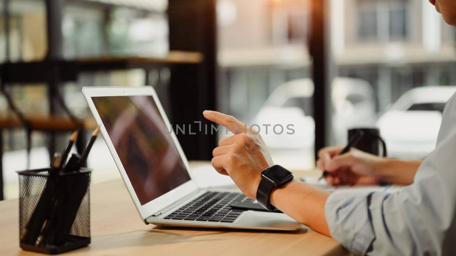 Close up of business analyst calculating financial data at desk.