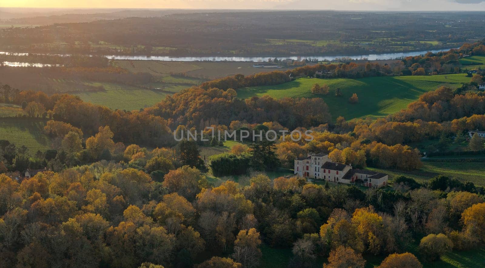 France, Gironde, Tabanac, Aerial view of the vineyard and wooded areas of Chateau le Pic in the Bordeaux vineyards at sunset. High quality photo