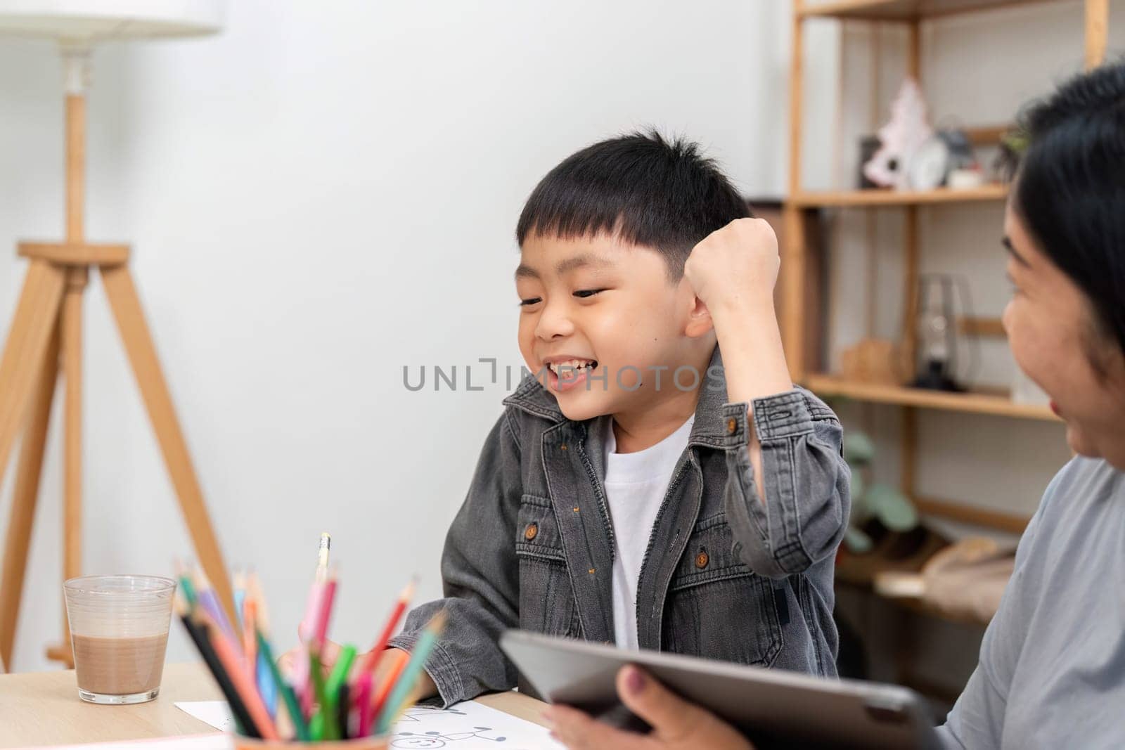 A cheerful child expresses joy and excitement while interacting with a parent, showcasing the importance of encouragement and support in learning.