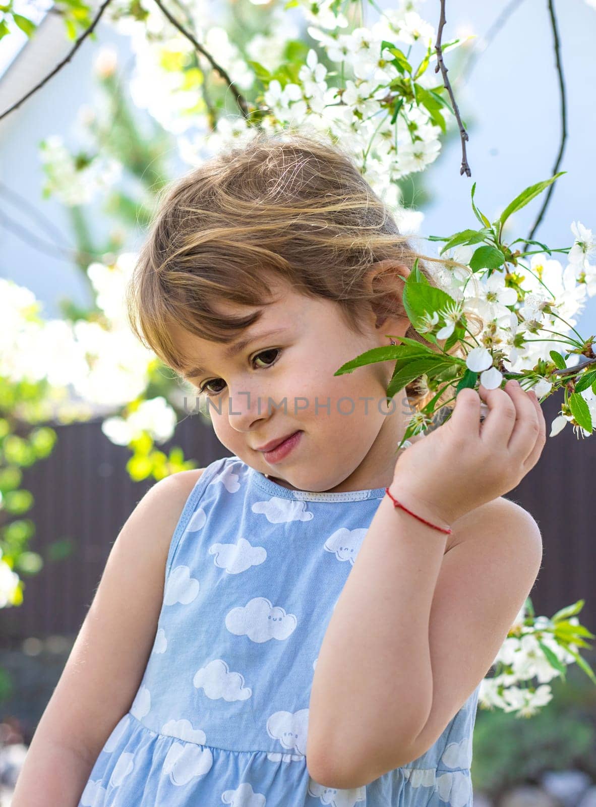 Child in a garden of flowering trees. Selective focus. kid.