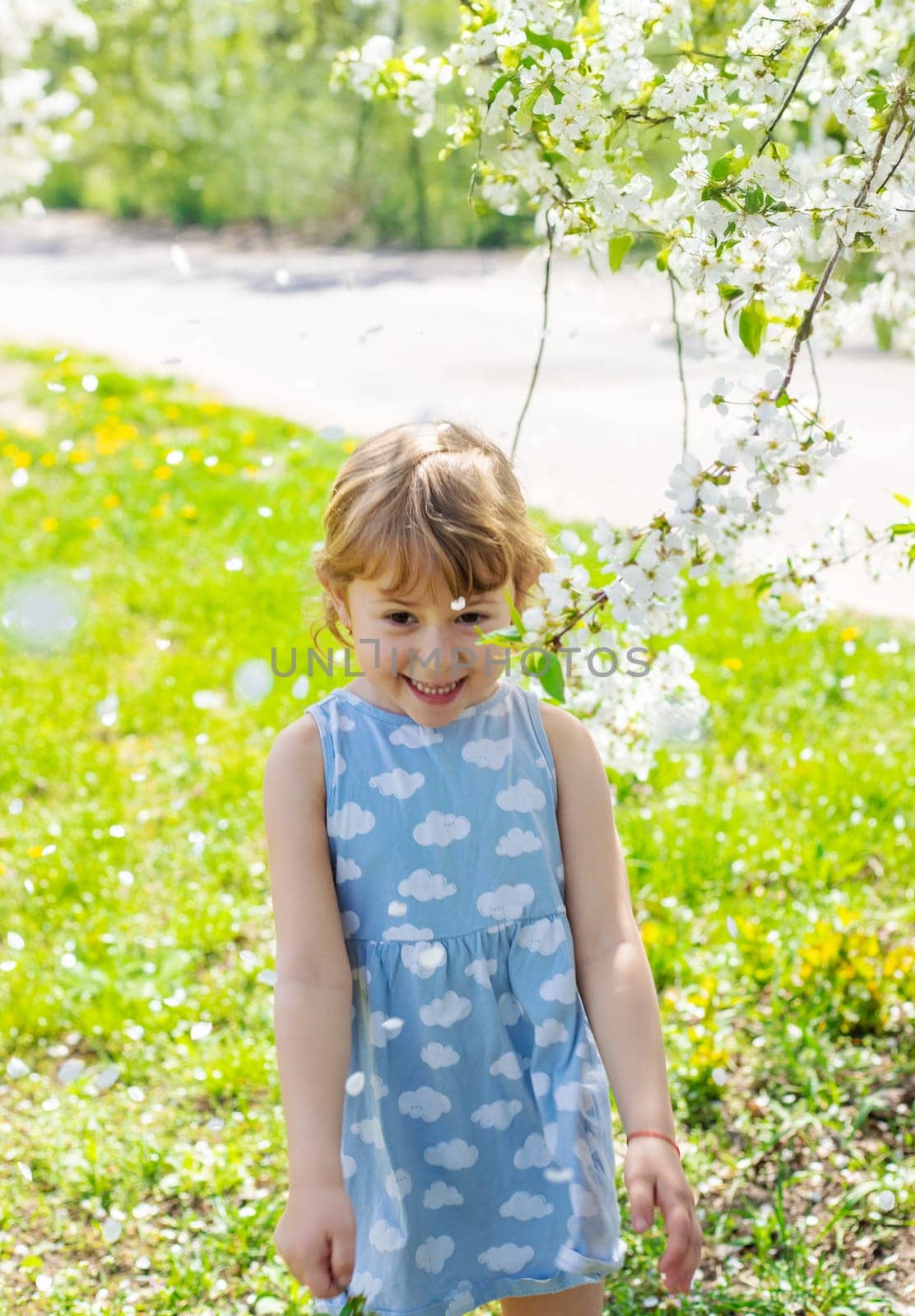 Child in a garden of flowering trees. Selective focus. kid.