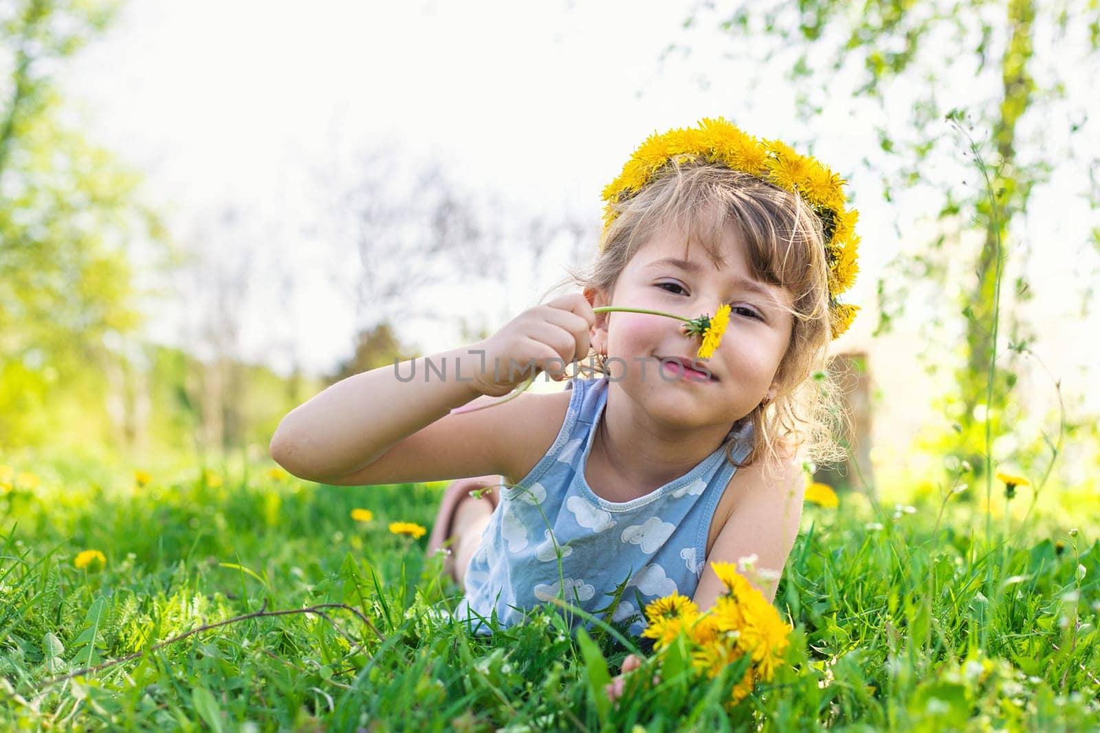Child in the garden with a bouquet of dandelions. Selective focus. Kid.