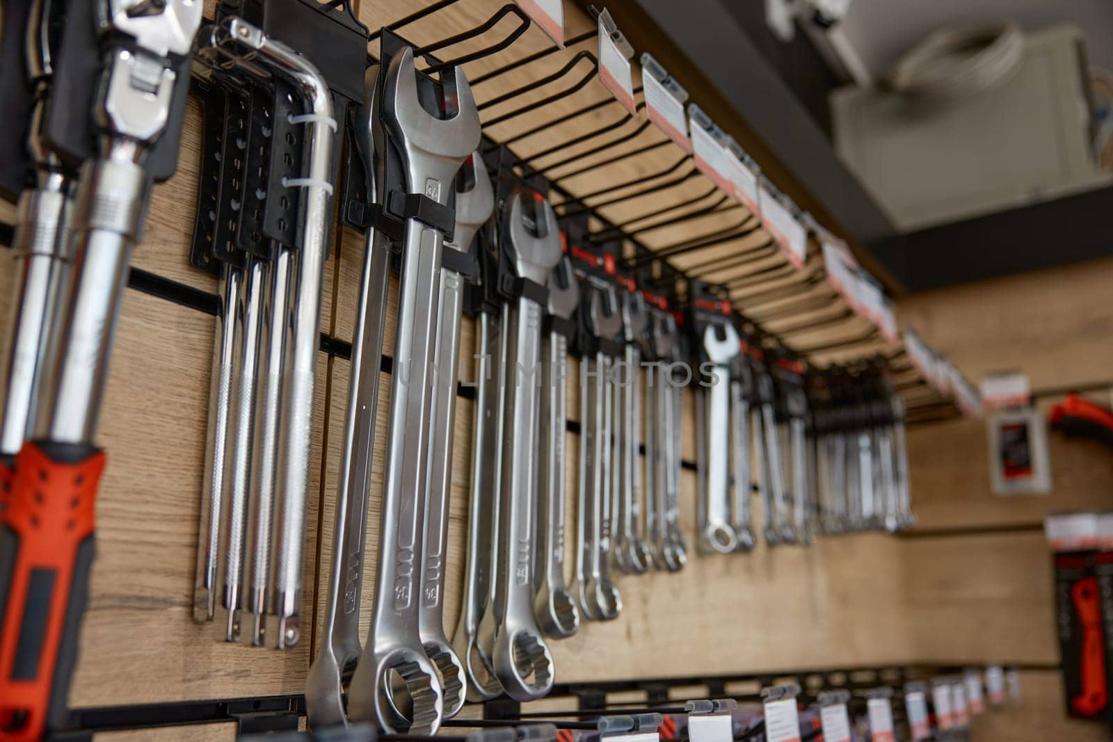 Displayed tools panel rack with wrenches, spanners and hydraulic jacks. Mechanical instruments workshop and hardware store assortment