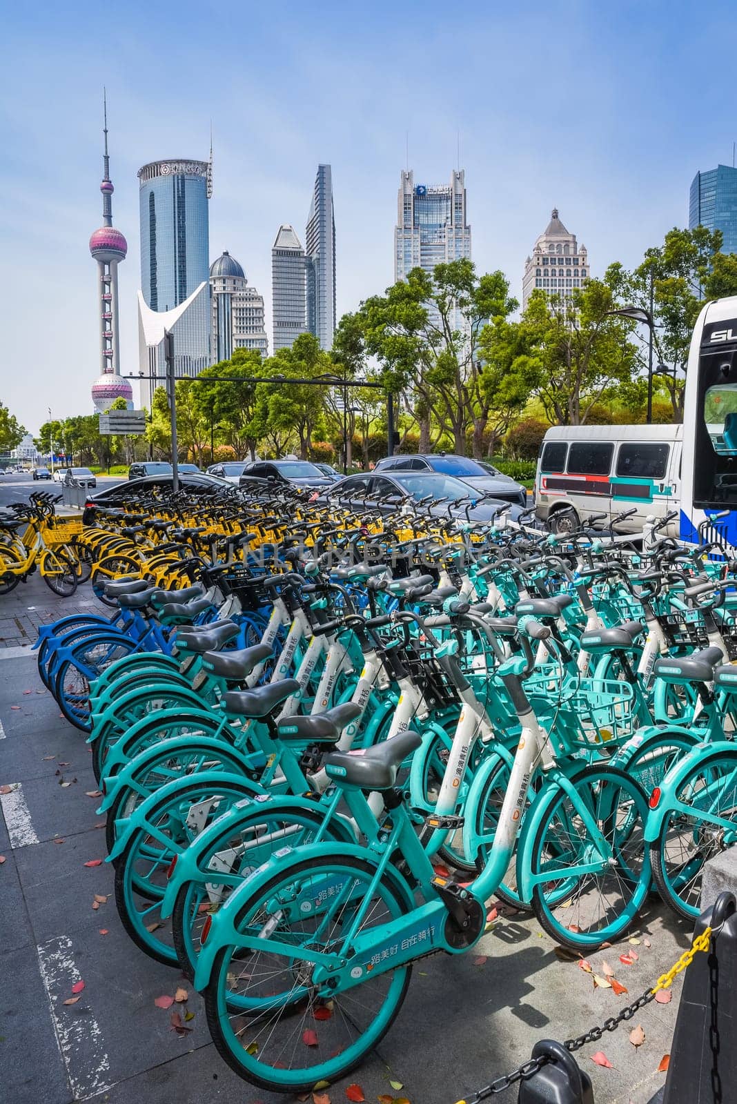 Shanghai, China - 1 April 2025: Vertical shot of rental bikes with Oriental Pearl tower in background. Shanghai skyline visible. No people