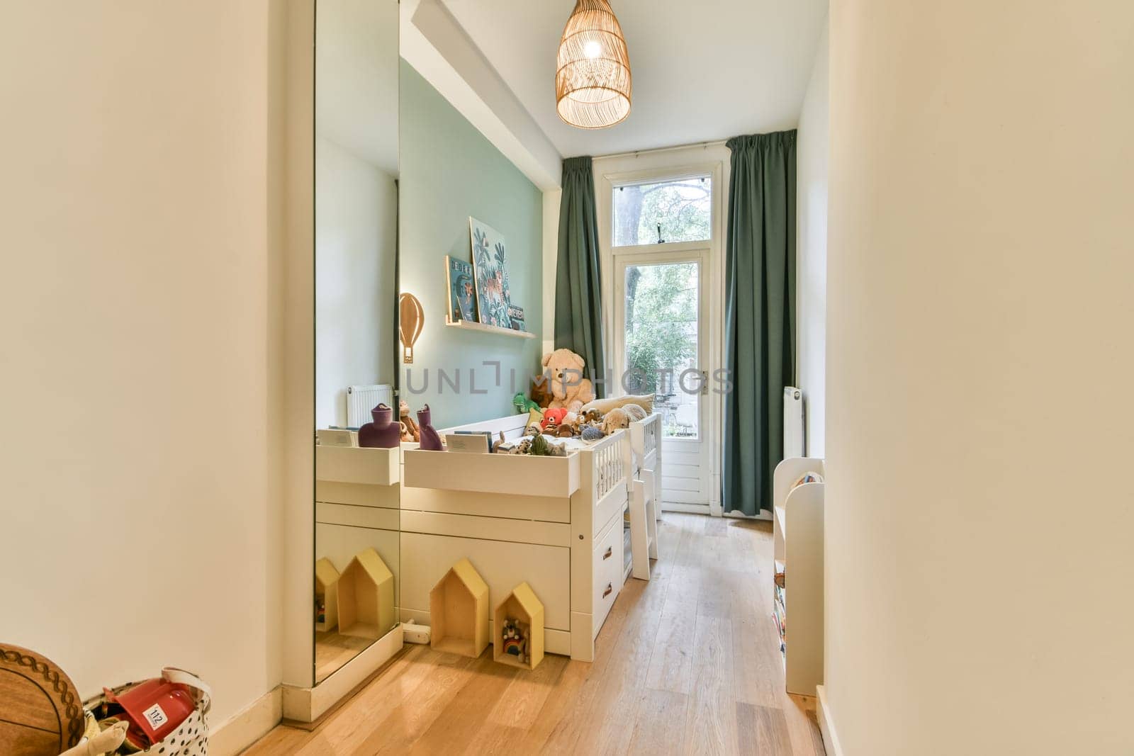 A spacious interior hallway with a playful design, featuring a mirror, decorative elements, and ample natural light. The stylish decor enhances the inviting atmosphere.
