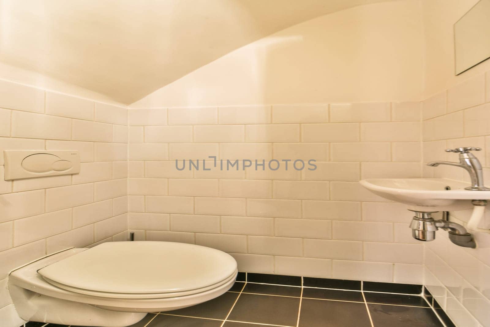 A sleek modern bathroom featuring pristine white tiles, a minimalist toilet, and an elegant wash basin. The clean lines and soft lighting create a serene atmosphere.